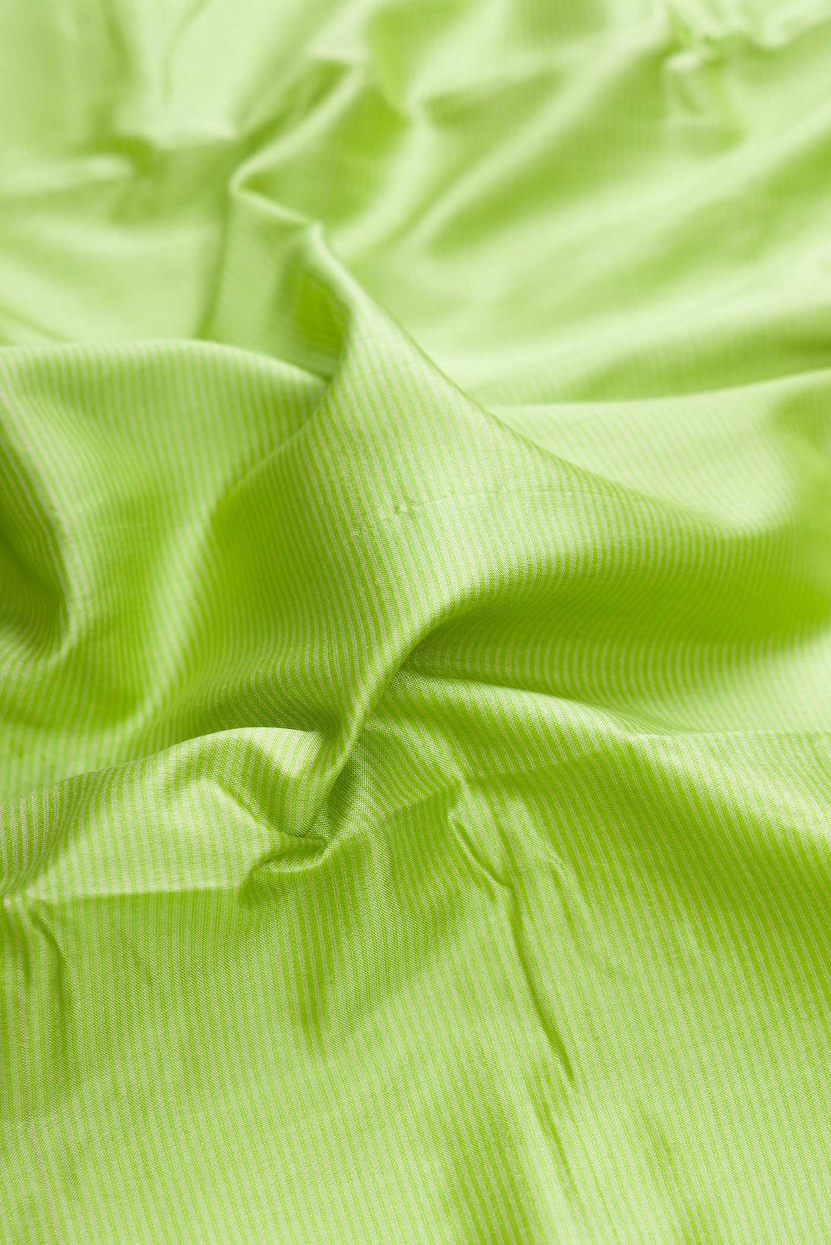 Close up of Parrot Green Dual Tone Maheshwari Silk Saree with Stripes on the body and Zari Border displaying folds