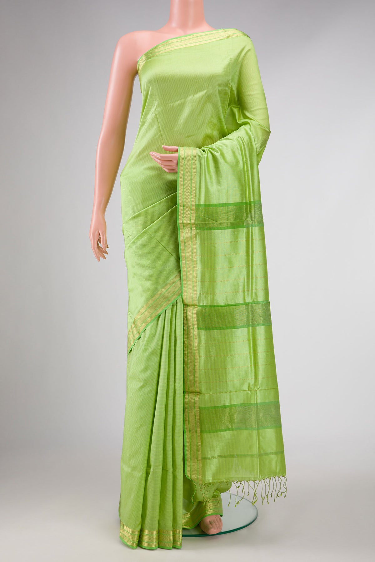 Parrot Green Dual Tone Maheshwari Silk Saree with Stripes on the body and Zari Border displayed on a mannequin
