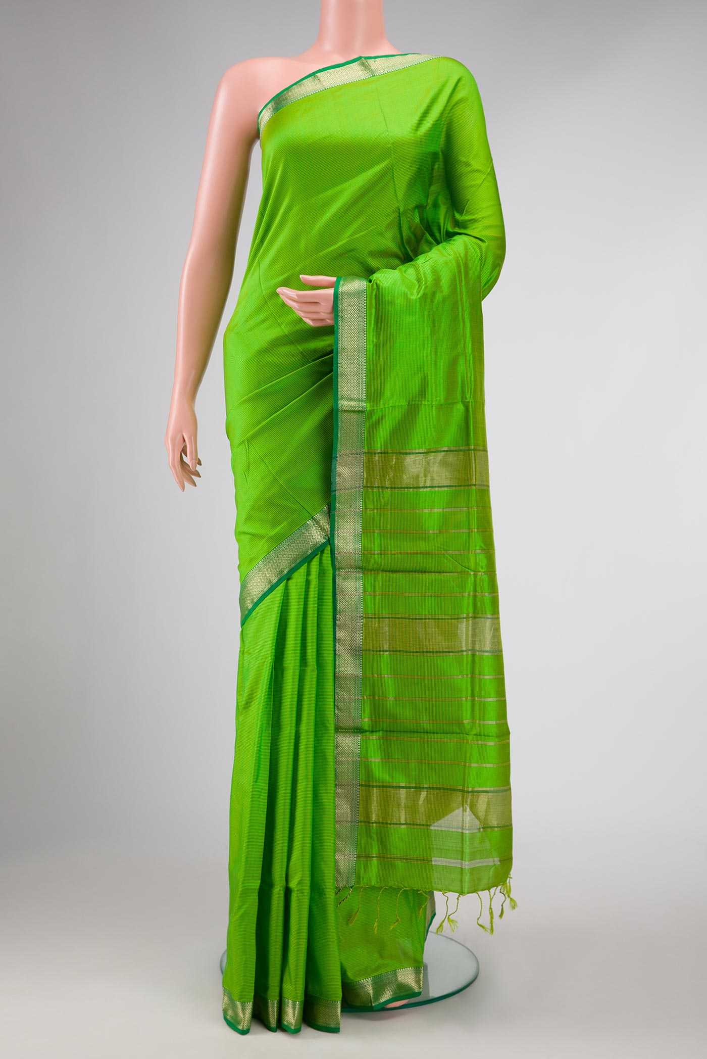 Parrot Green Dual Tone Maheshwari Silk Saree with Stripes on the body and Zari Border displayed on a mannequin