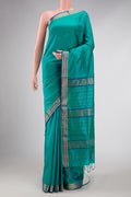 Green Dual Tone Maheshwari Silk Saree with Stripes on the body and Zari Border displayed on a mannequin