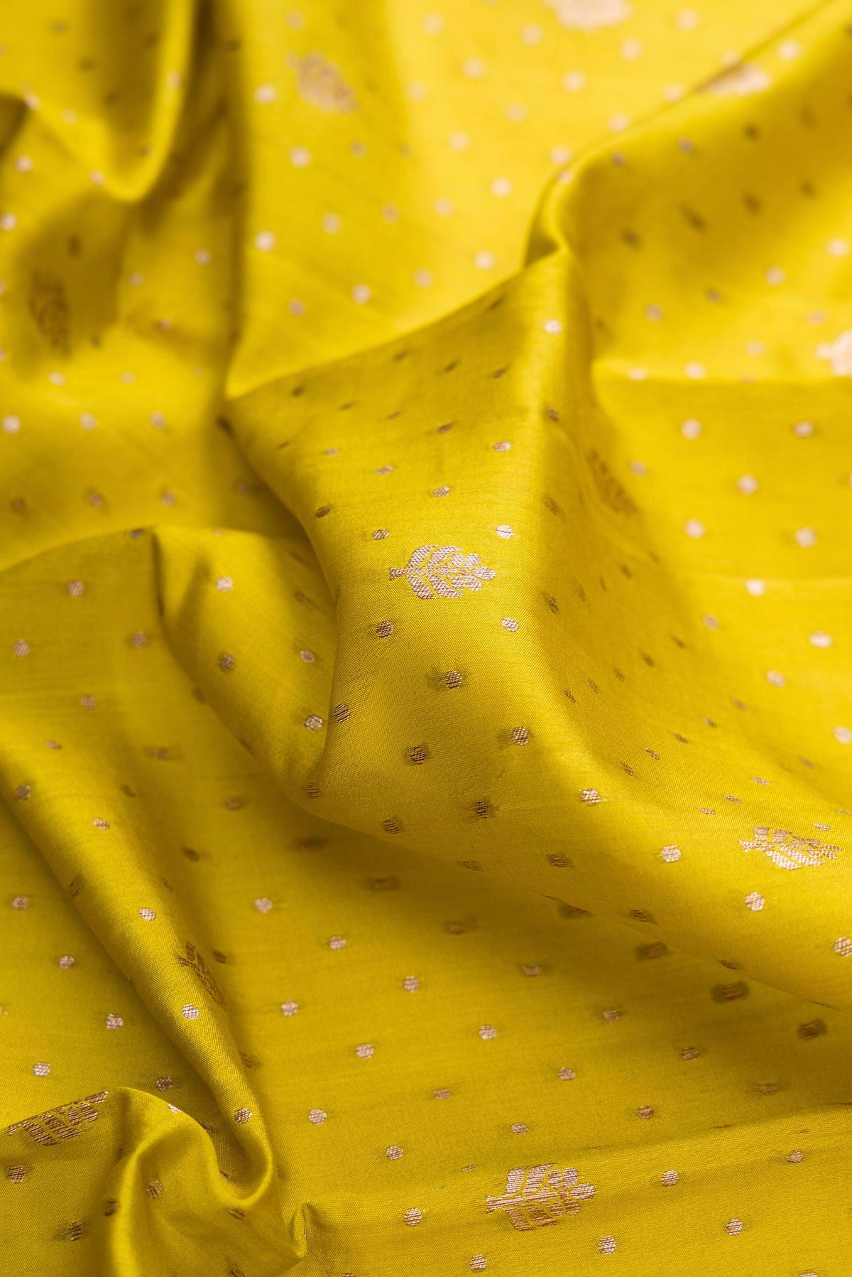 Close up of Mehandi Green Dual Tone Tussar Silk Saree with Checked design on the body and Zari Border displaying folds
