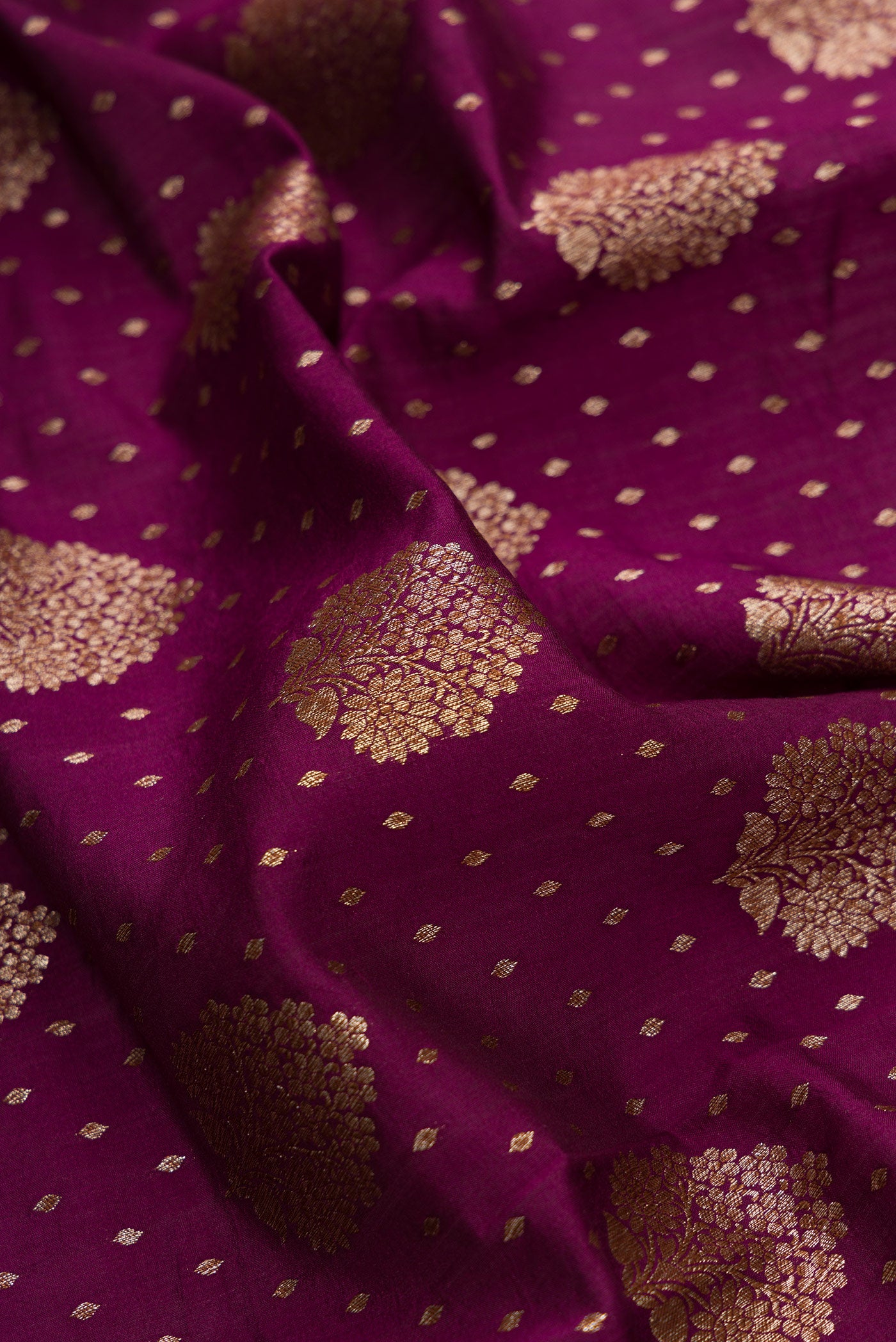 Close up of Burgundy Dual Tone Tussar Silk Saree with Zari Brocade on the body and Zari Border.  displaying folds