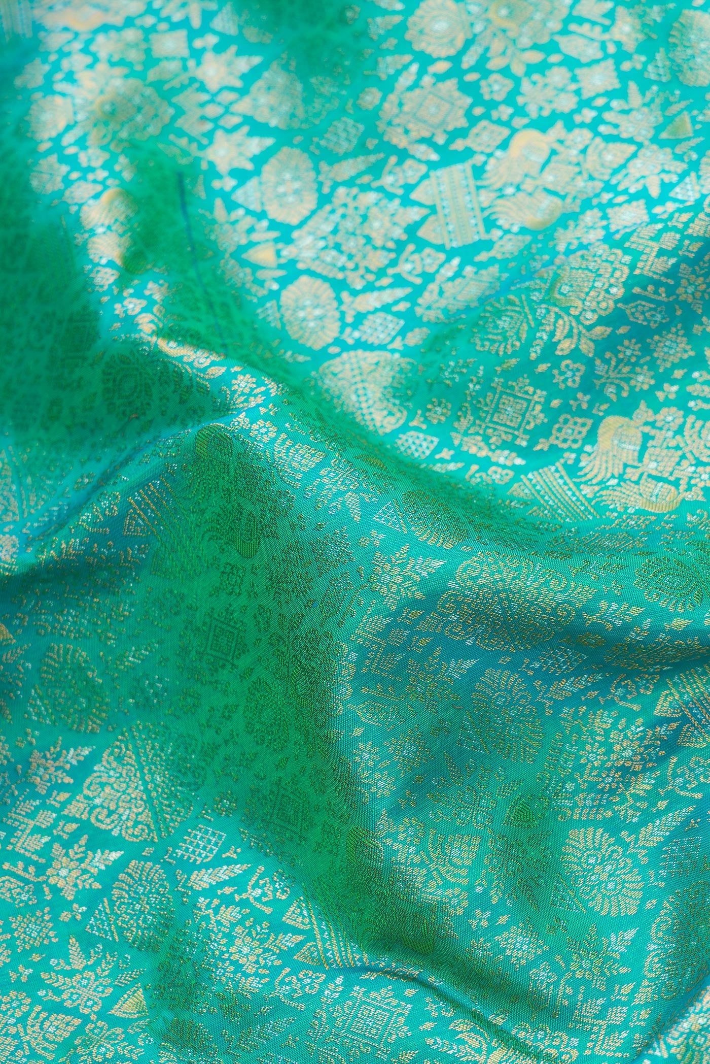 Close up of Sea Green Dual Tone Kanchipuram Silk Saree with Zari Brocade on the body and Fancy Border.  displaying folds