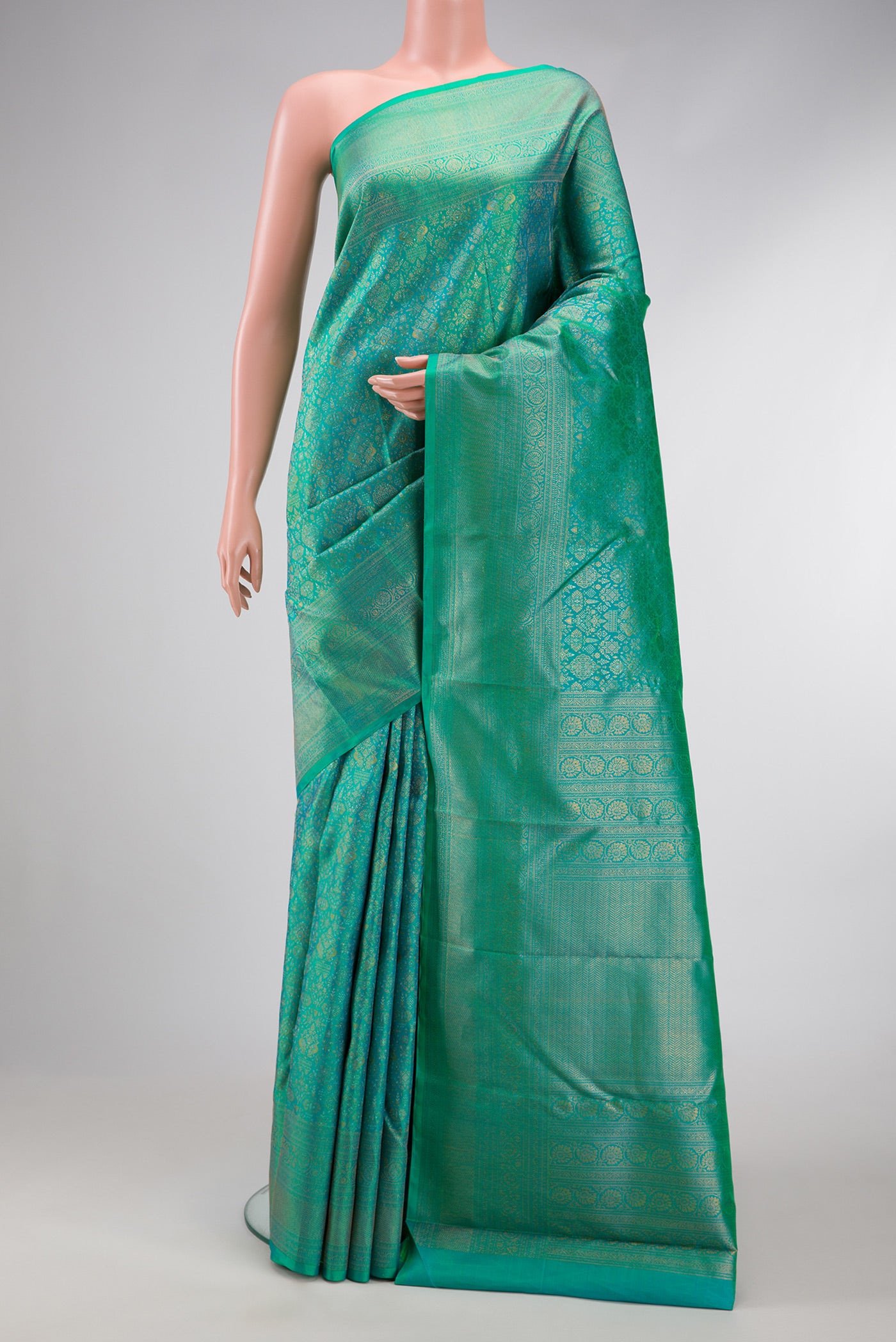 Sea Green Dual Tone Kanchipuram Silk Saree with Zari Brocade on the body and Fancy Border.  displayed on a mannequin