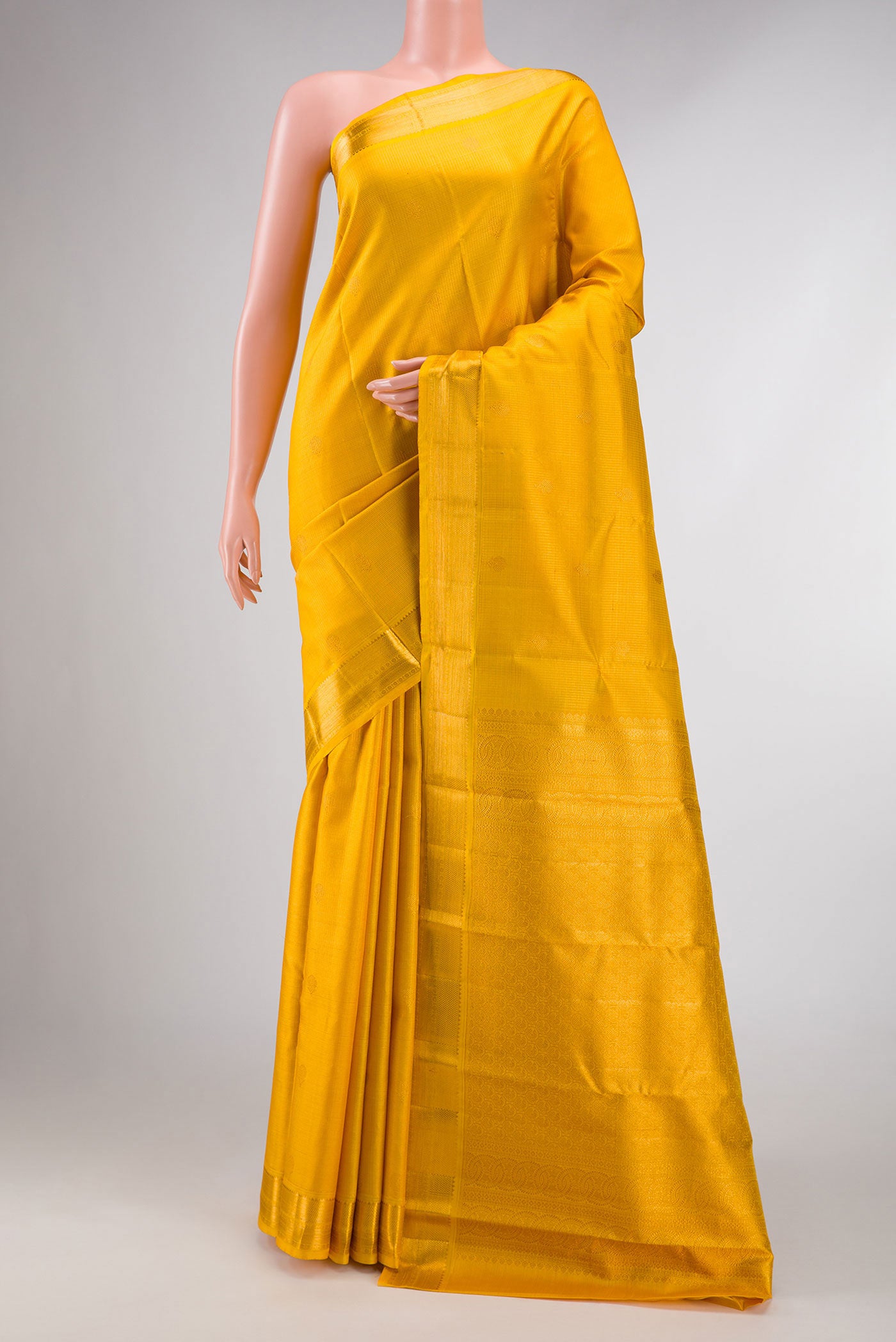 Yellow Dual Tone Kanchipuram Silk Saree with Zari Butta on the body and Zari Border displayed on a mannequin