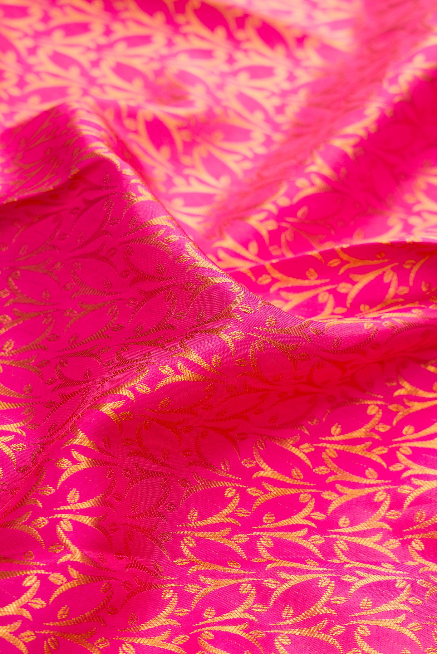 Close up of Pink Dual Tone Kanchipuram Silk Saree with Zari Brocade on the body and Zari Border.  displaying folds