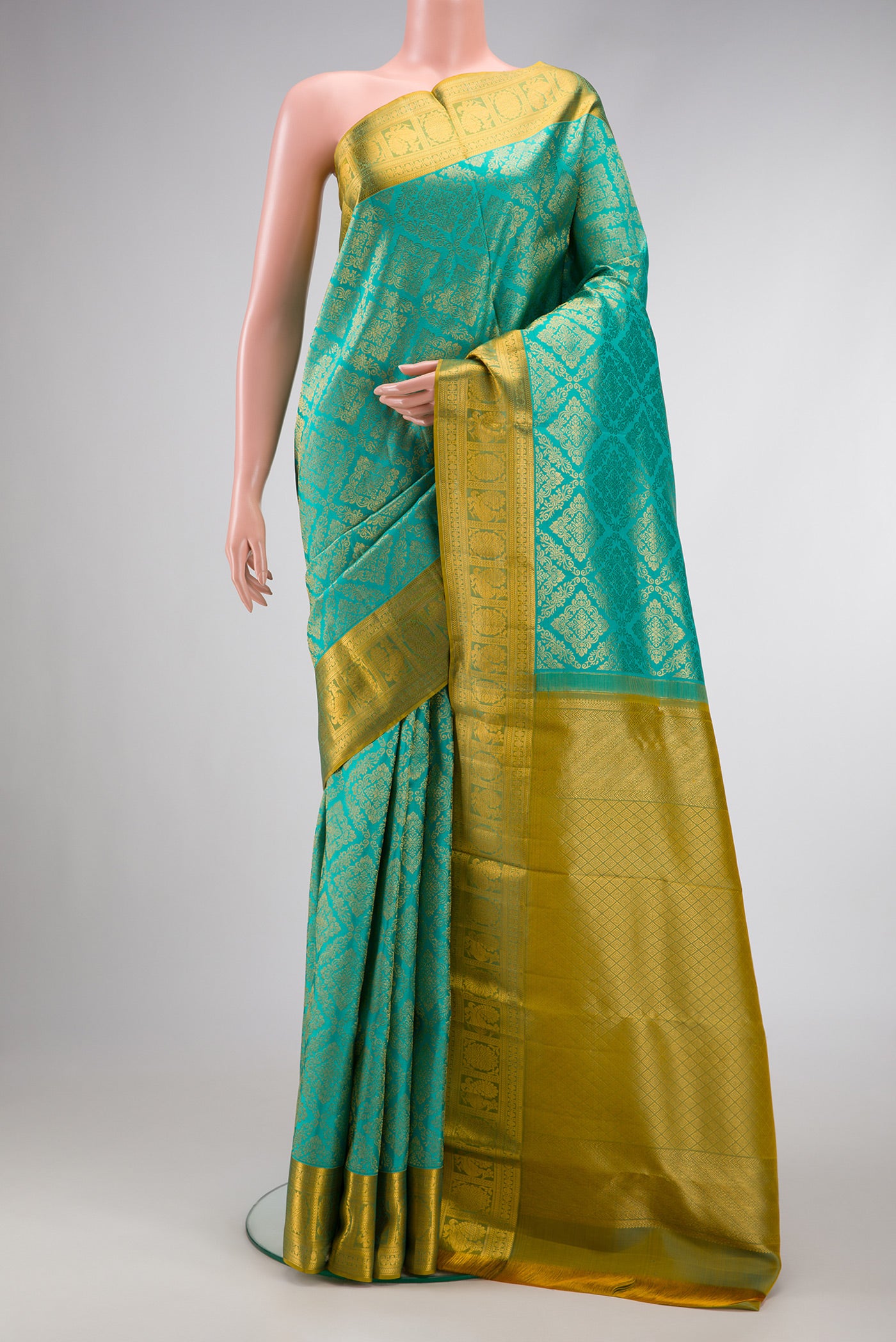 Sea Green Dual Tone Kanchipuram Silk Saree with Zari Brocade on the body and Zari Border.  displayed on a mannequin