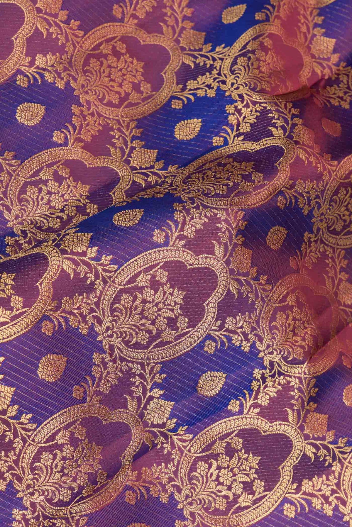 Close up of Purple Dual Tone Kanchipuram Saree with Zari Brocade on the body and Zari Border displaying folds