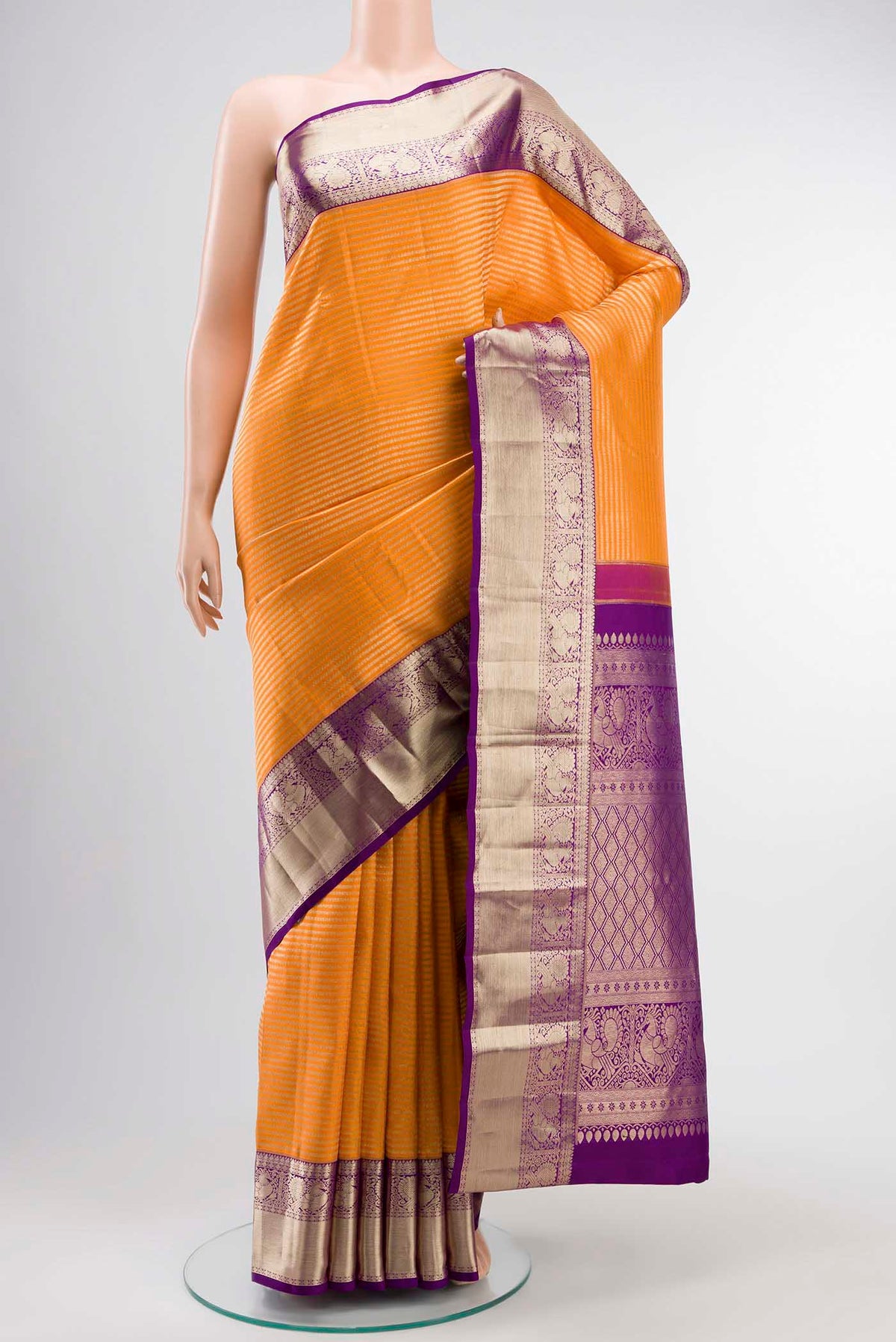 Orange Kanchipuram Silk Saree with Stripes on the body and Zari Border displayed on a mannequin