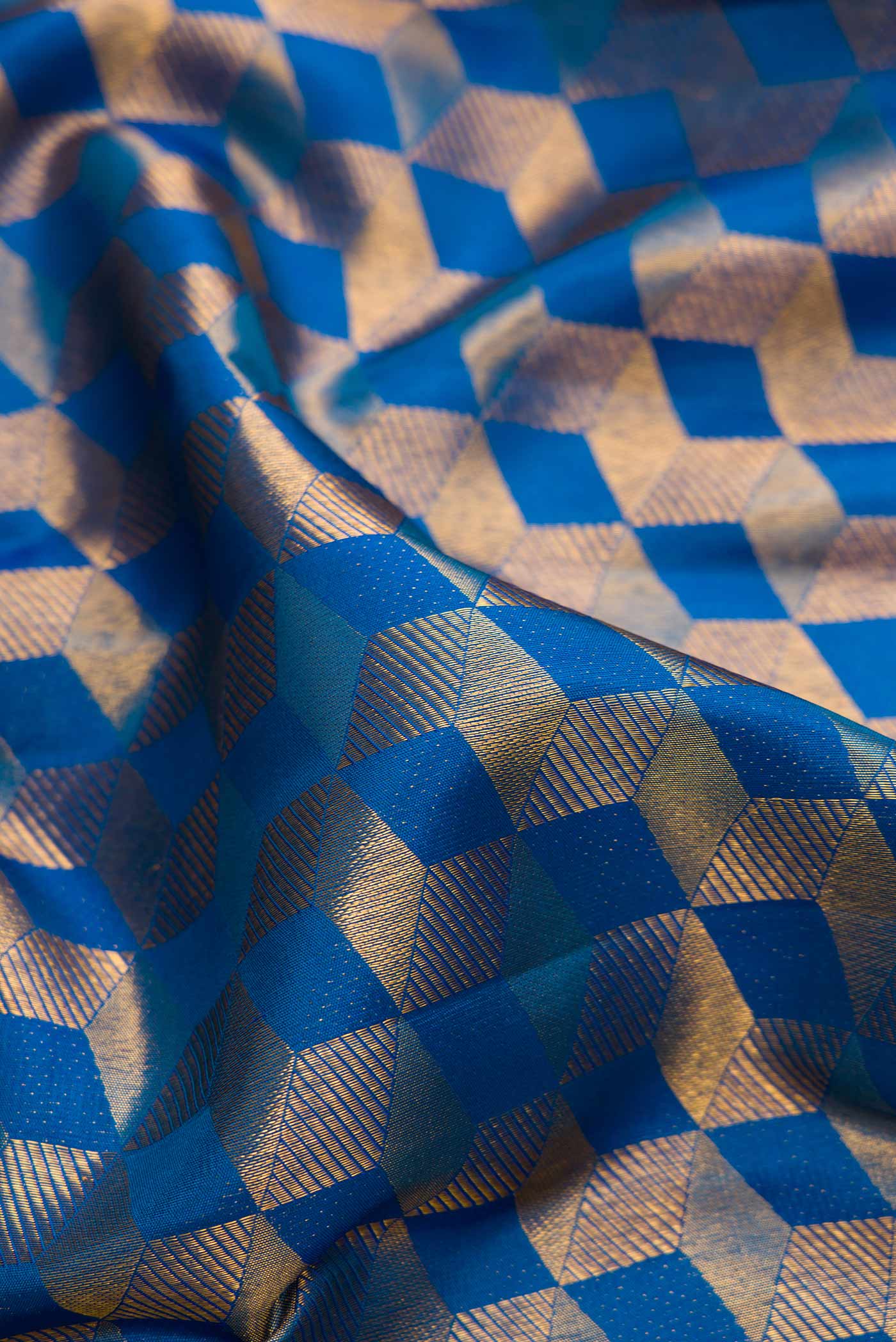 Close up of Peacock Blue Dual Tone Kanchipuram Silk Saree with Zari Brocade on the body and Zari Border.  displaying folds