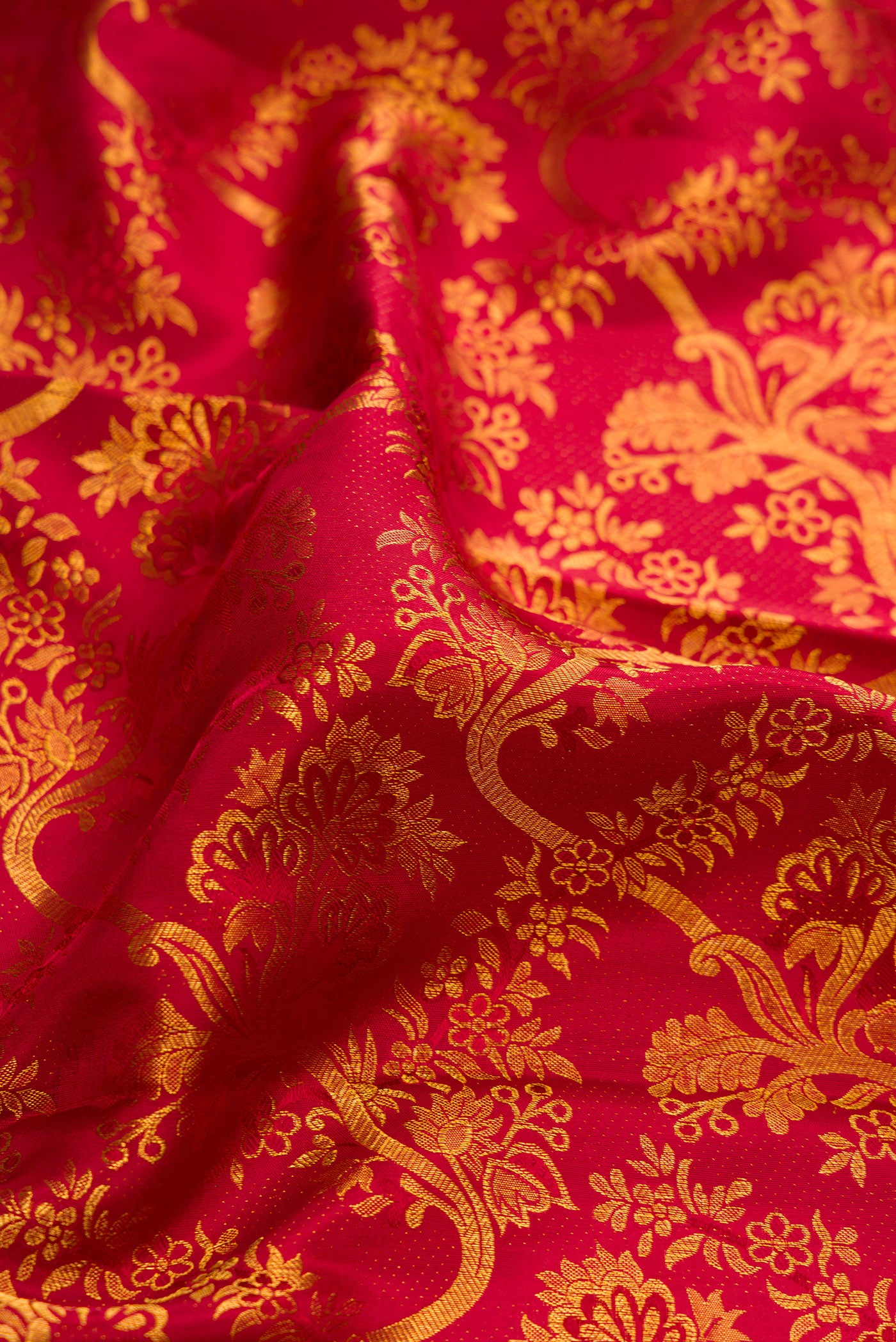Close up of Maroon Dual Tone Kanchipuram Silk Saree with Zari Brocade on the body and Zari Border.  displaying folds