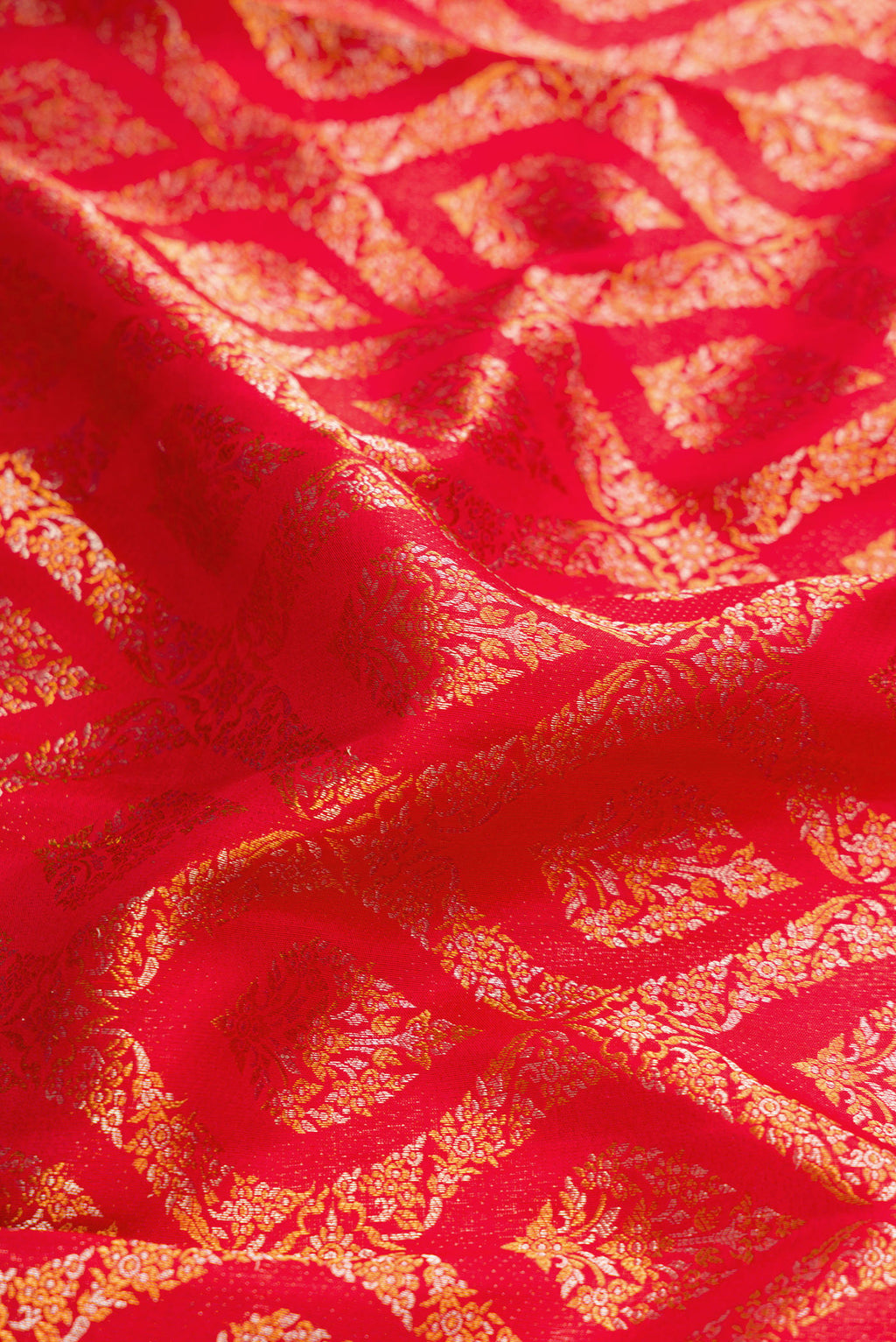 Close up of Red Dual Tone Kanchipuram Silk Saree with Zari Brocade on the body and Zari Border.  displaying folds