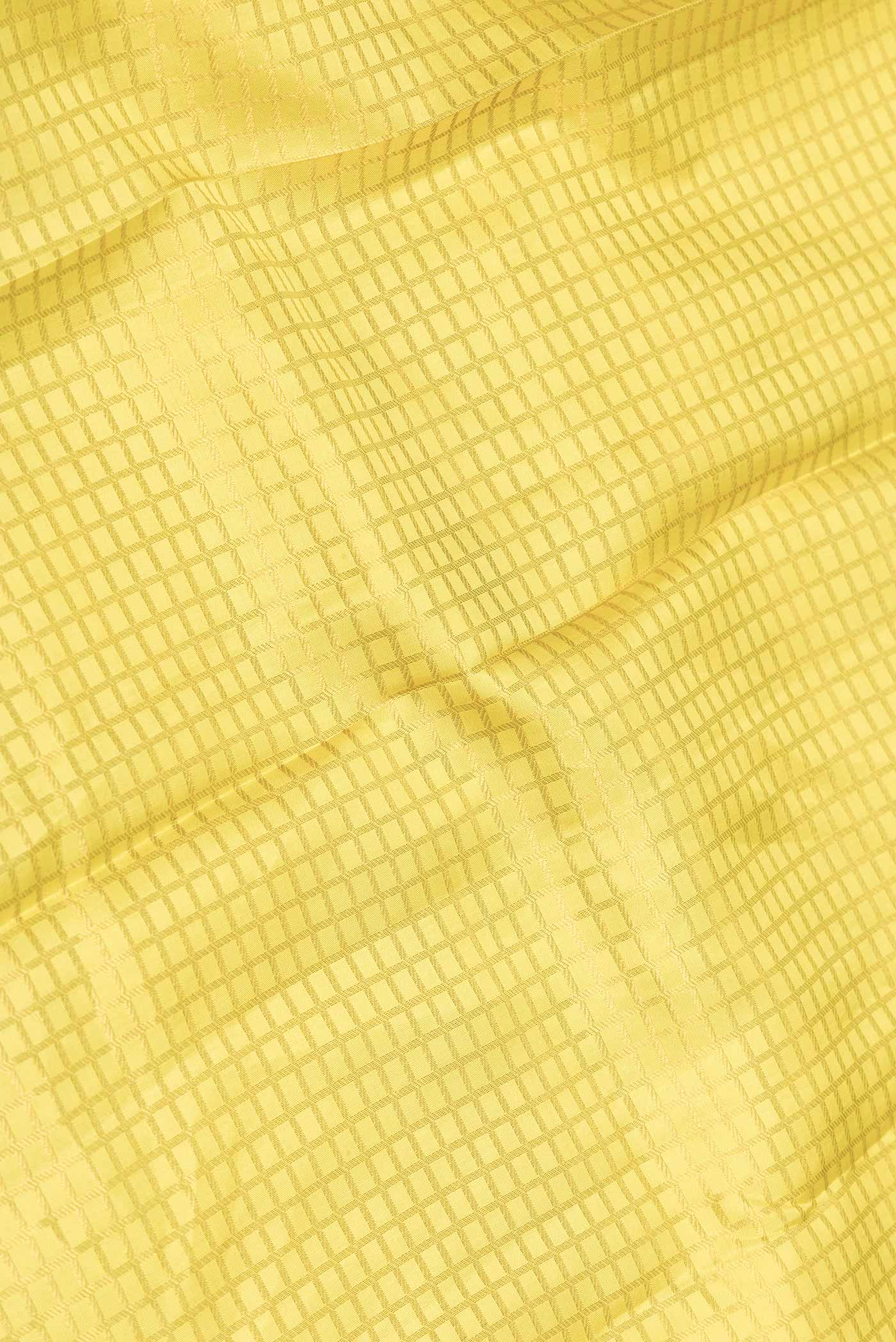Close up of Yellow Dual Tone Kanchipuram Saree with Zari Brocade on the body and Zari Border displaying folds