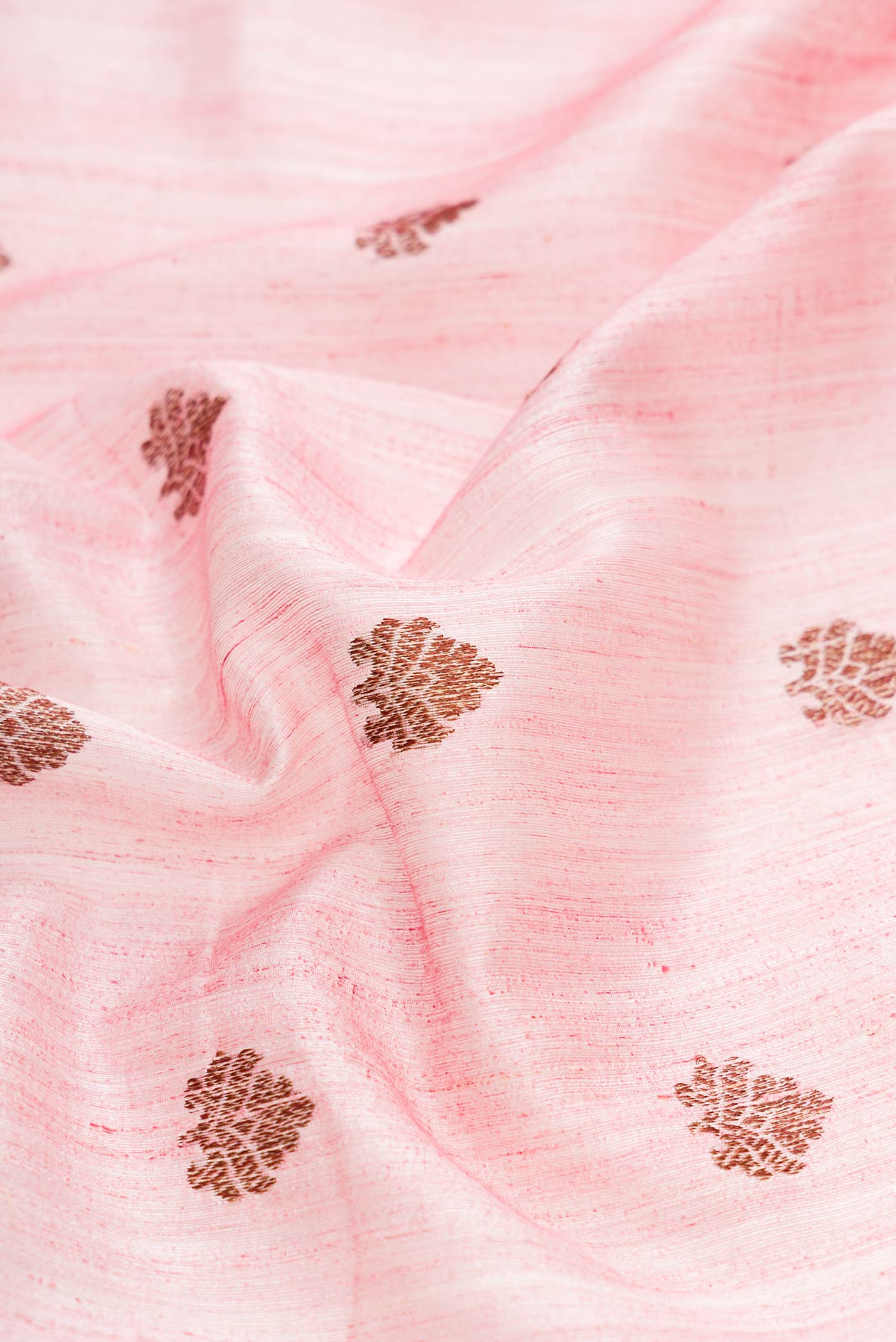 Close up of Pink Dual Tone Raw Silk Saree with Zari Butta on the body and Zari Border displaying folds