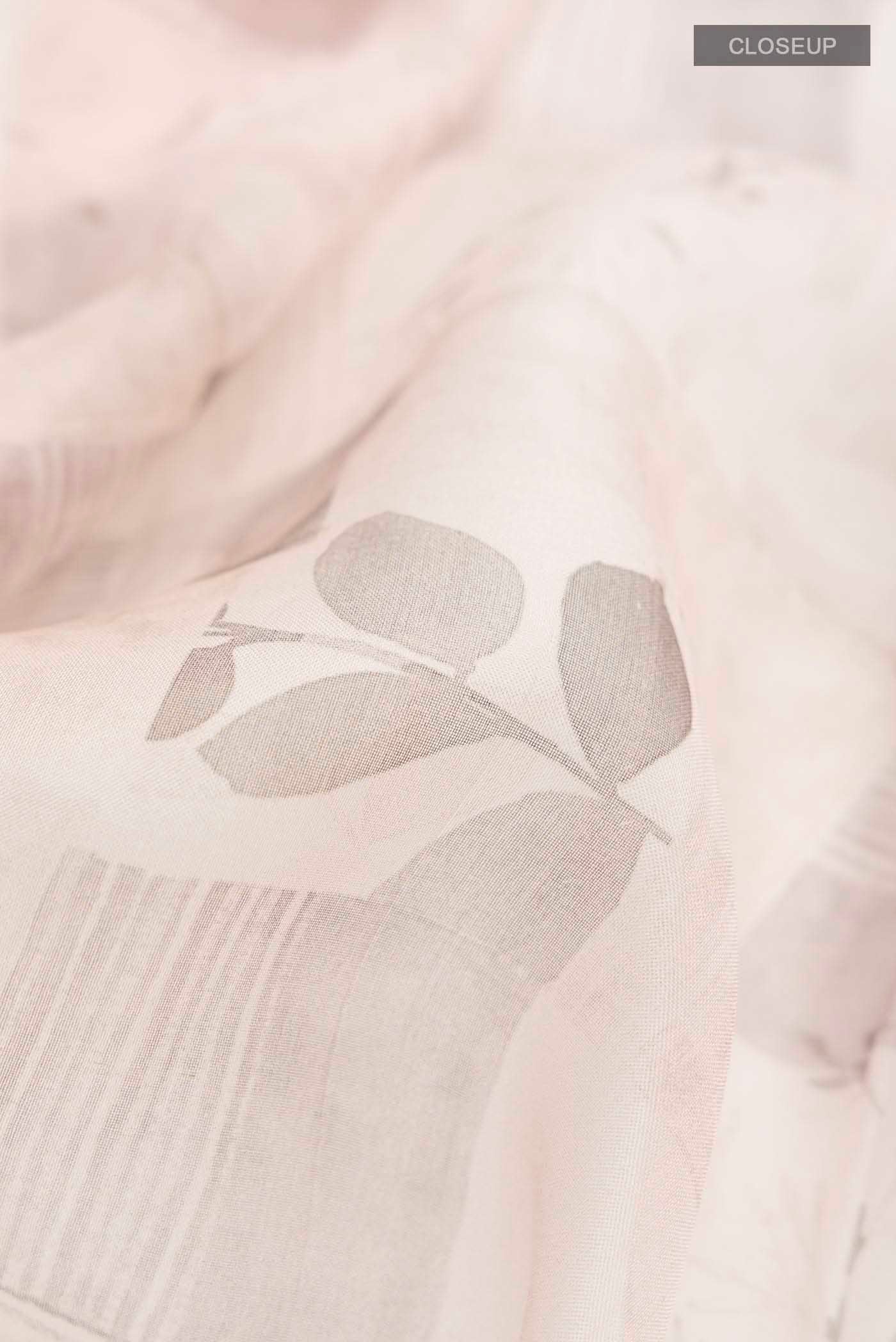 Close up of Mauve Organza Silk Saree with Printed design on the body and Plain Border displaying folds