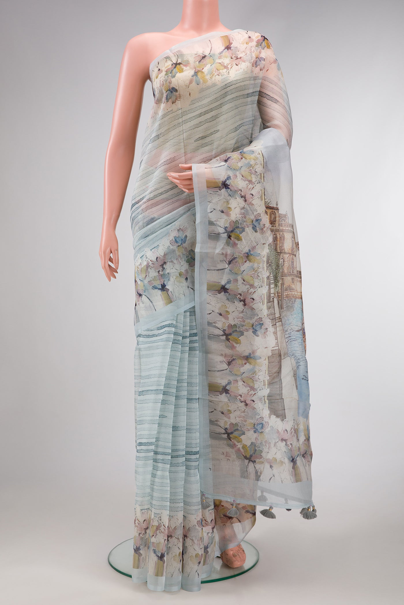 Grey Dual Tone Organza Silk Saree with Printed design on the body and Zari Border.  displayed on a mannequin