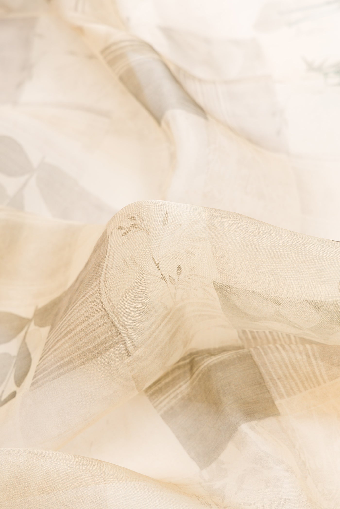 Close up of Sandal Dual Tone Organza Silk Saree with Printed design on the body and Zari Border.  displaying folds