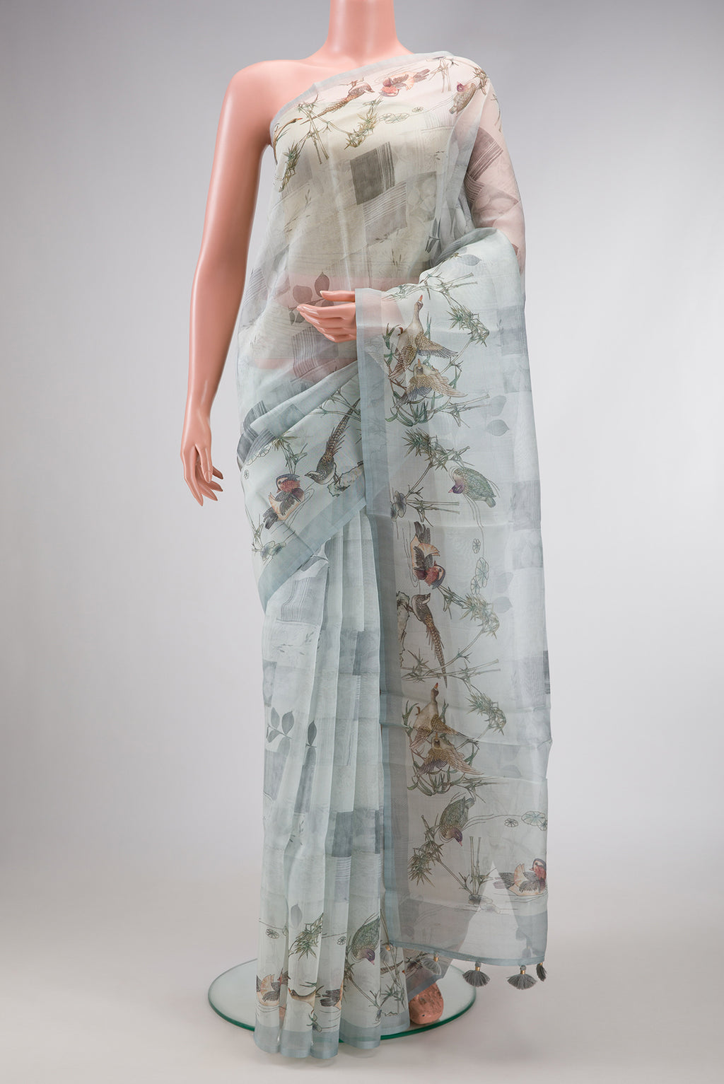 Grey Dual Tone Organza Silk Saree with Printed design on the body and Plain Border.  displayed on a mannequin
