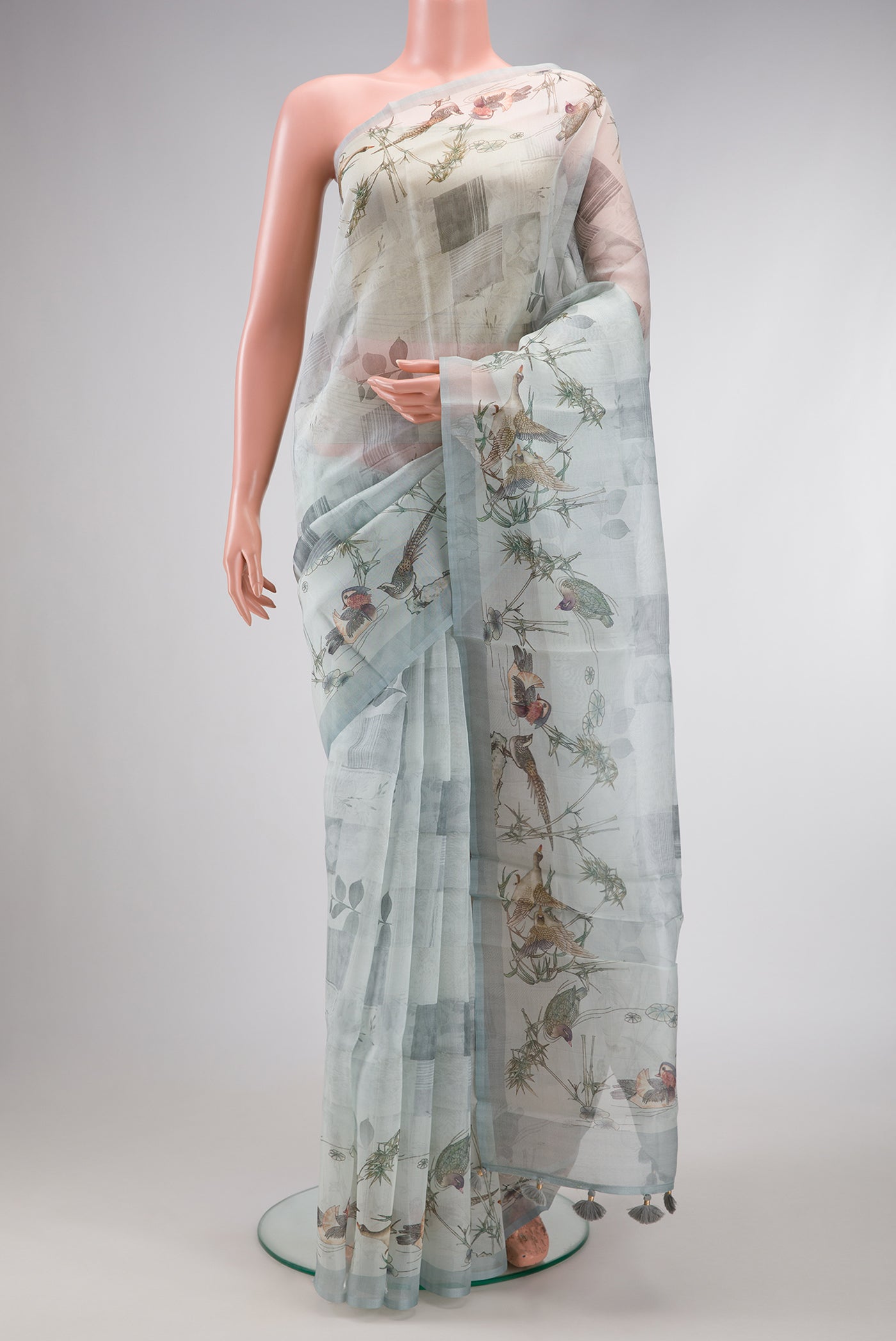Grey Dual Tone Organza Silk Saree with Printed design on the body and Plain Border.  displayed on a mannequin