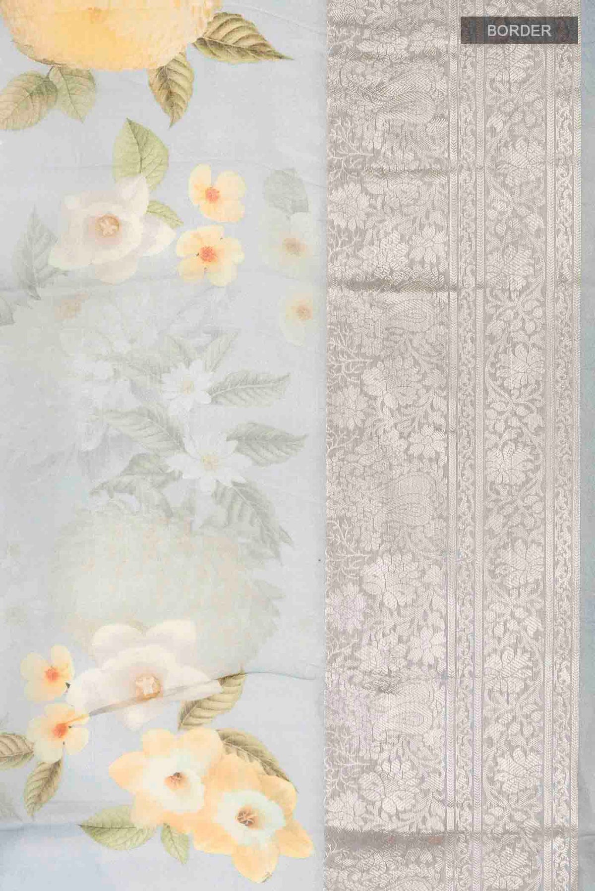 Border image of Grey Organza Silk Saree with Printed design on the body and Zari Border