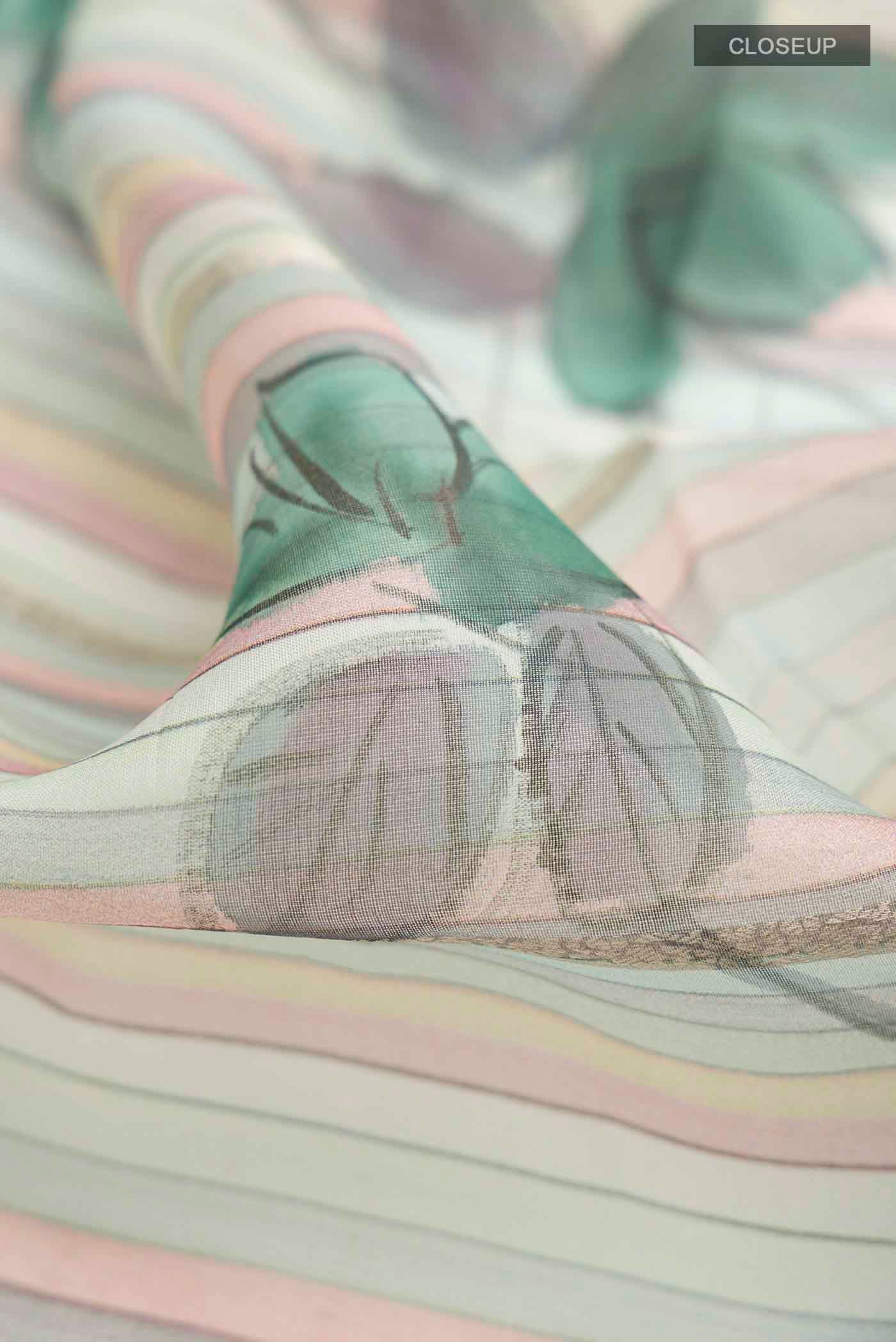 Close up of Blue Organza Silk Saree with Stripes on the body and Zari Border displaying folds