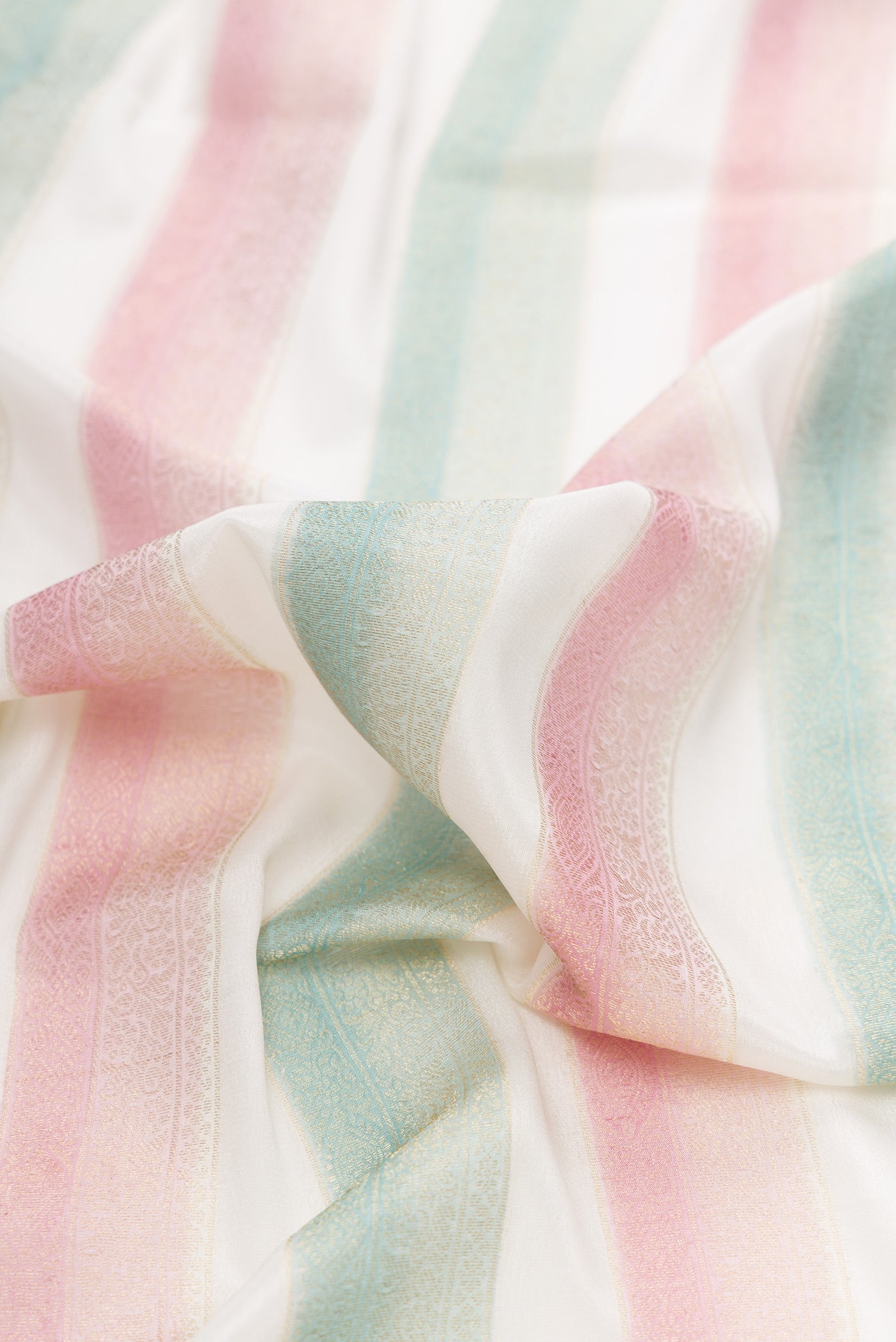 Close up of Pink and Green Color Mysore Silk Saree with Stripes on the body and Zari Border.  displaying folds