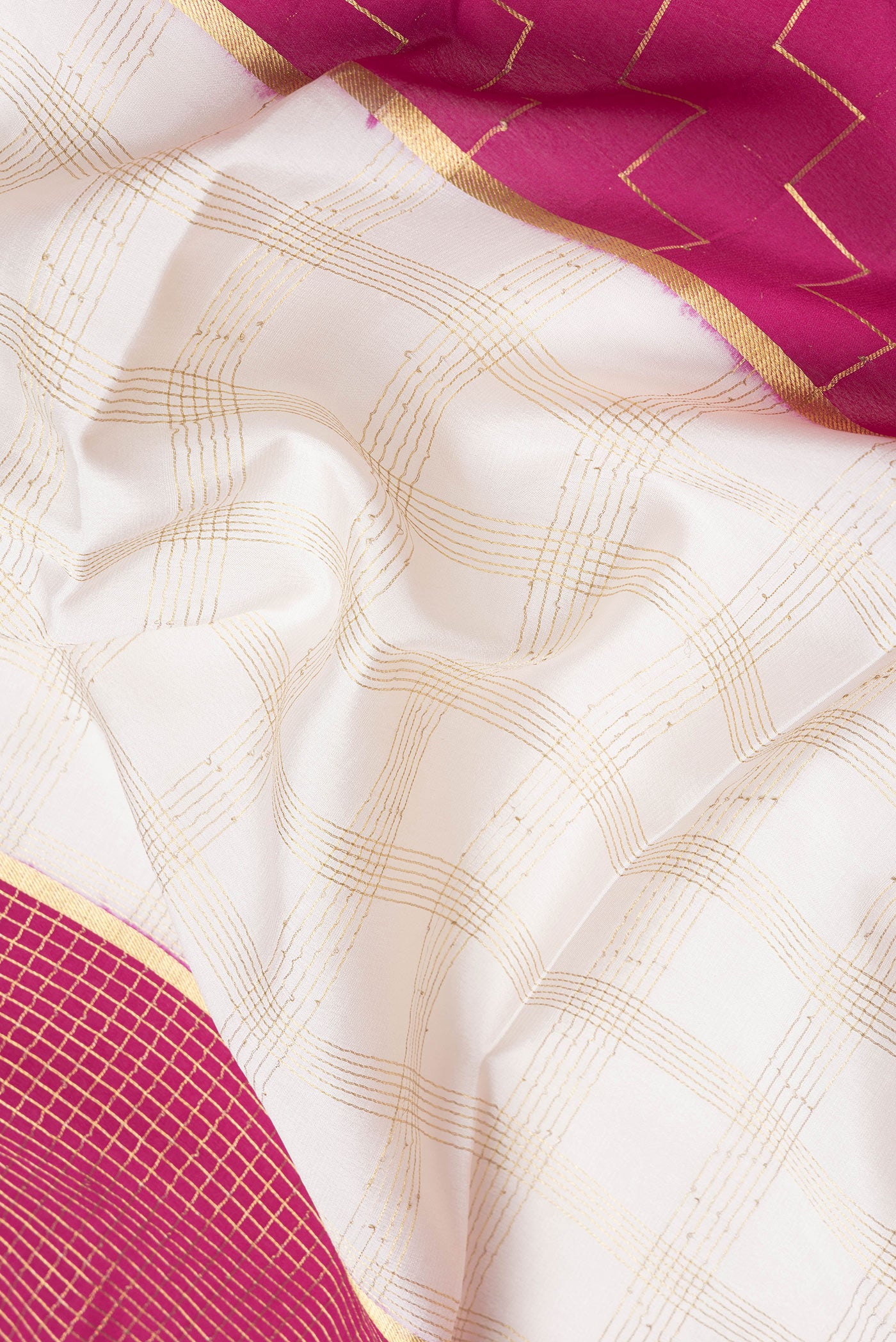 Close up of Pink and Off White Color Mysore Silk Saree with Checked design on the body and Zari Border.  displaying folds