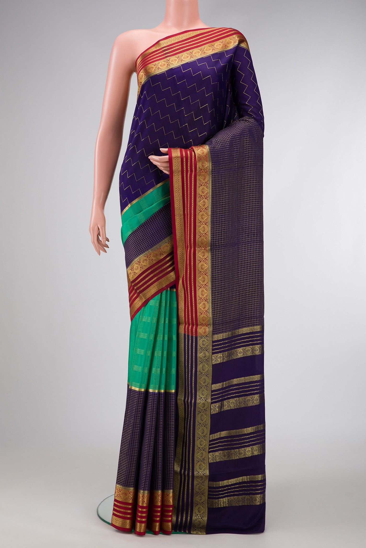 Navy Blue and Sea Green Color Mysore Silk Saree with Checked design on the body and Zari Border.  displayed on a mannequin