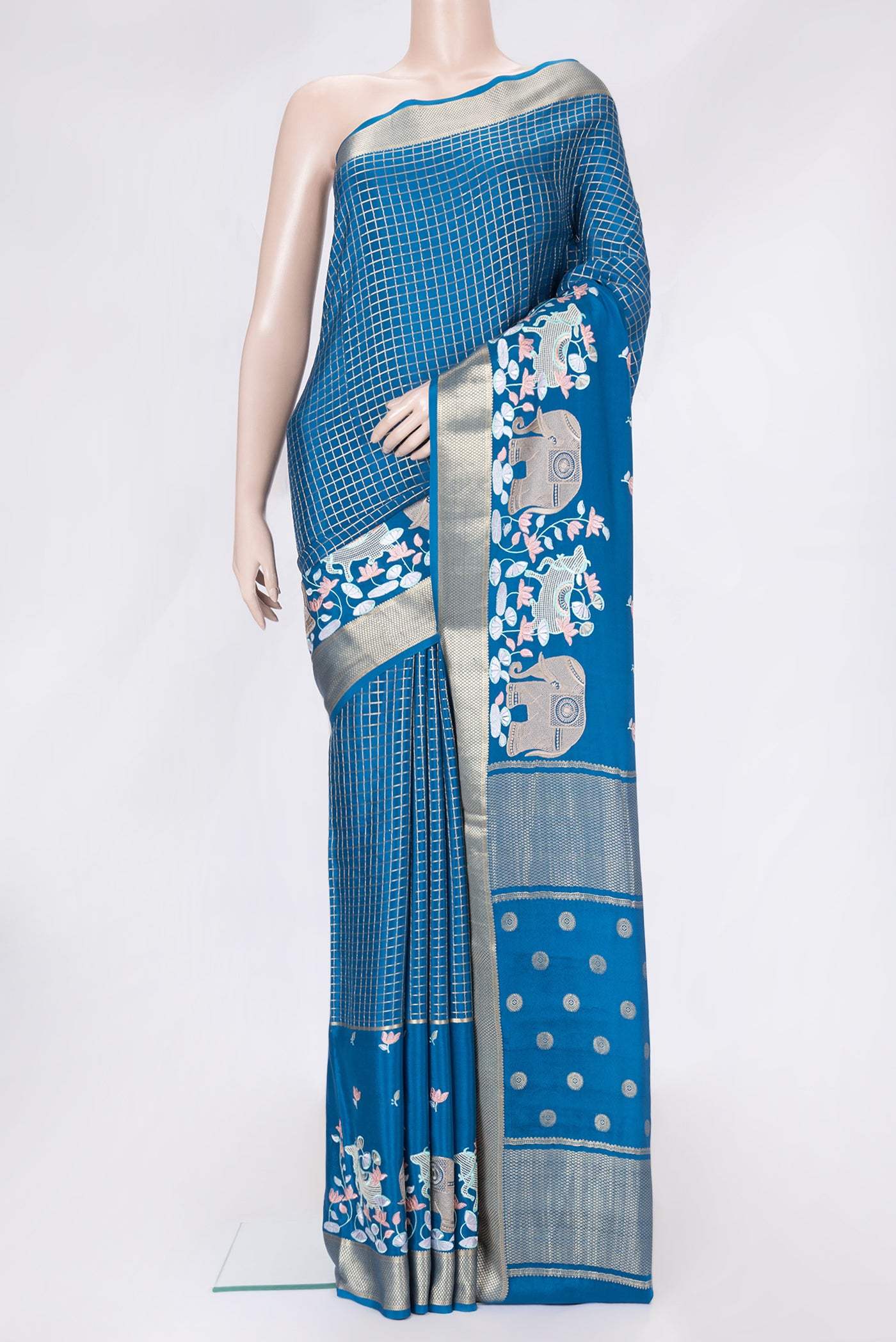 Peacock Blue Dual Tone Mysore Silk Saree with Checked design on the body and Embroidery Border.  displayed on a mannequin
