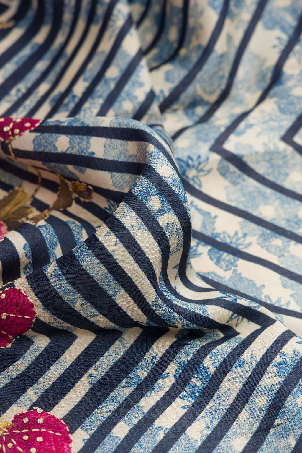Close up of Grey Dual Tone Tussar Silk Saree with Printed design on the body and Embroidery Border.  displaying folds
