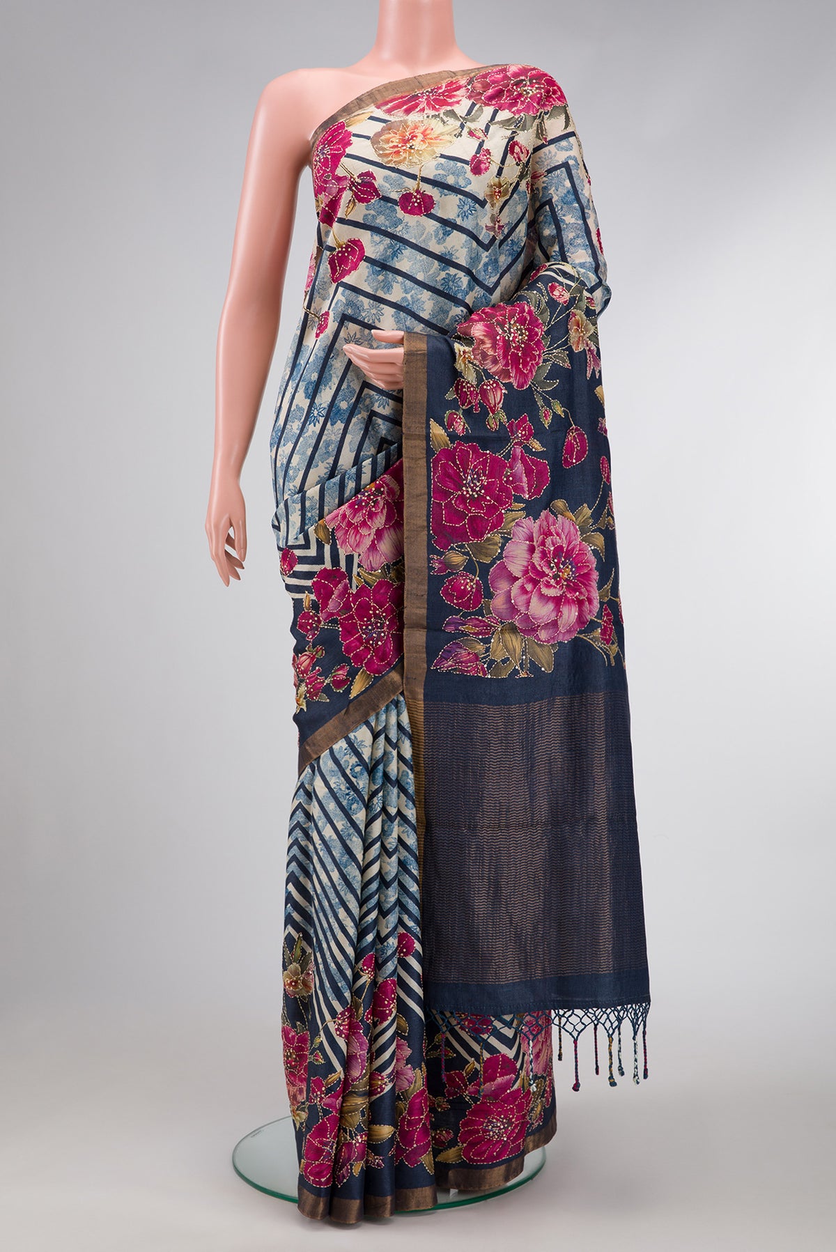 Grey Dual Tone Tussar Silk Saree with Printed design on the body and Embroidery Border.  displayed on a mannequin