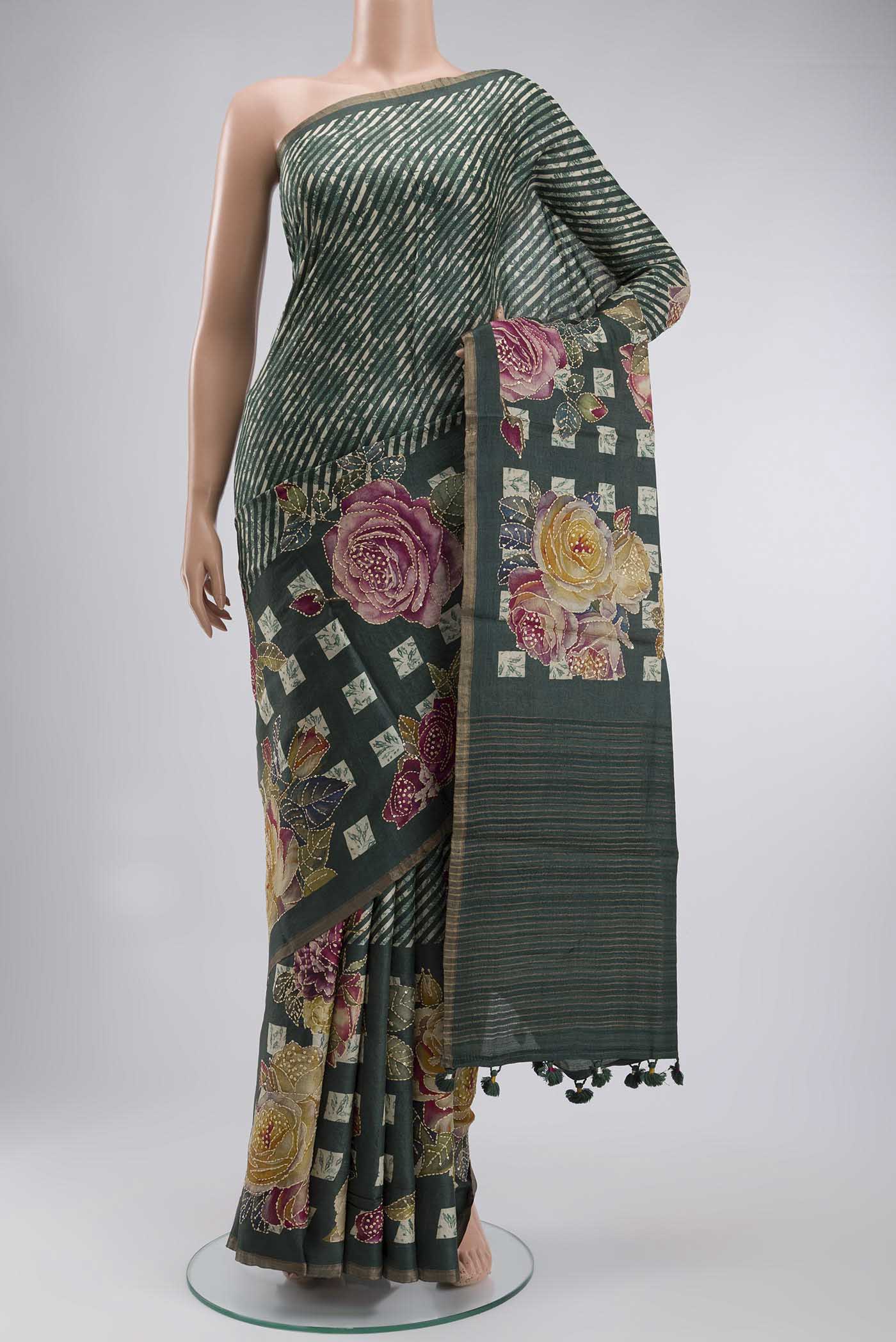 Green Tussar Silk Saree with Embroidery on the body and Zari And Thread Border displayed on a mannequin