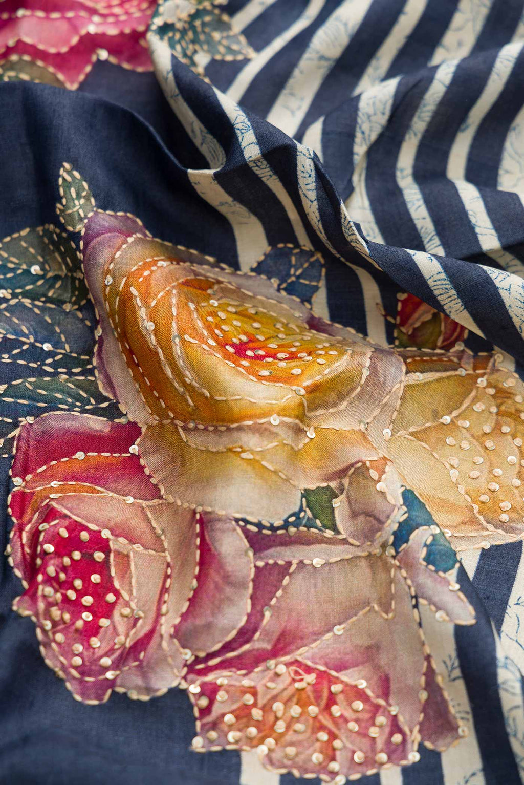 Close up of Navy Blue Dual Tone Tussar Silk Saree with Printed design on the body and Embroidery Border displaying folds