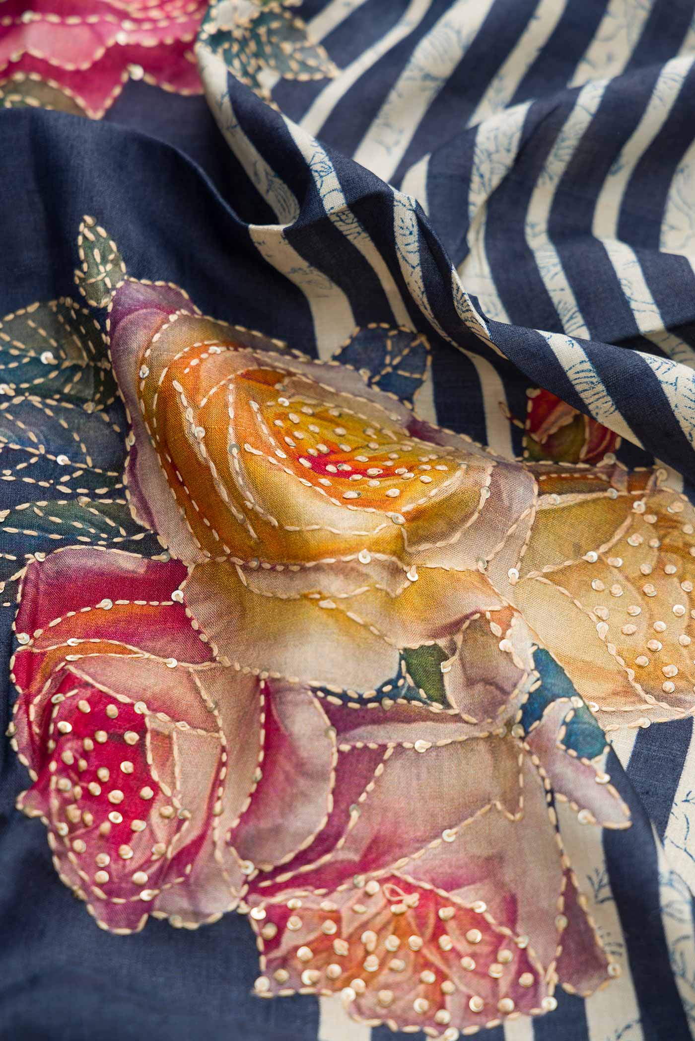 Close up of Navy Blue Dual Tone Tussar Silk Saree with Printed design on the body and Embroidery Border displaying folds