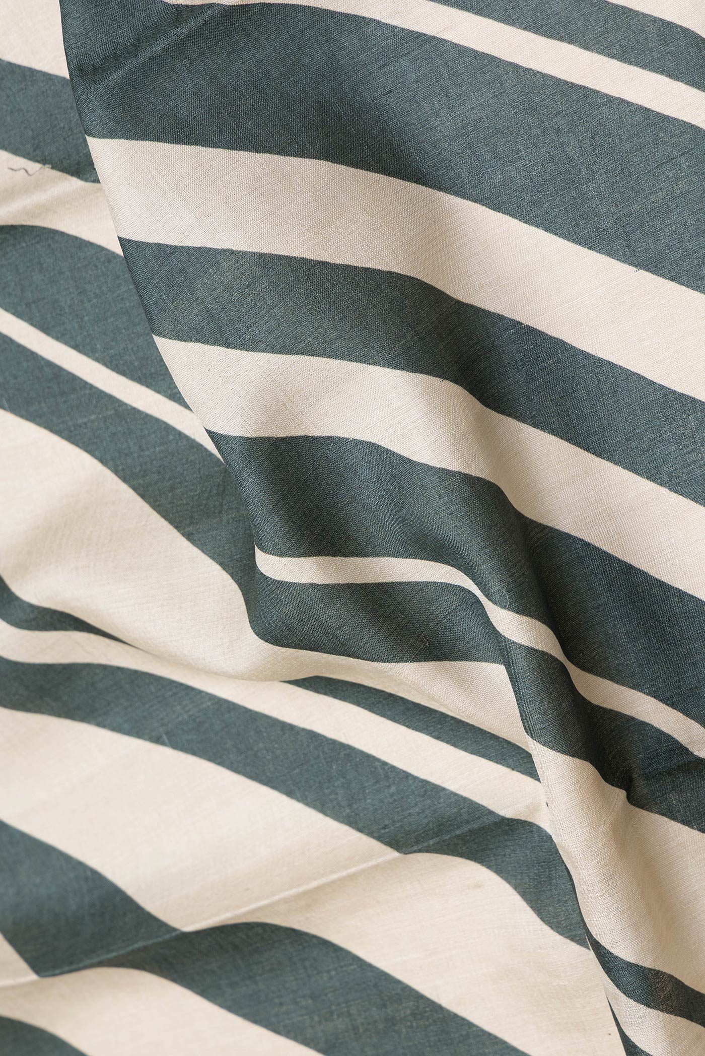 Close up of Green Dual Tone Tussar Silk Saree with Embroidery on the body and Embroidery Border.  displaying folds