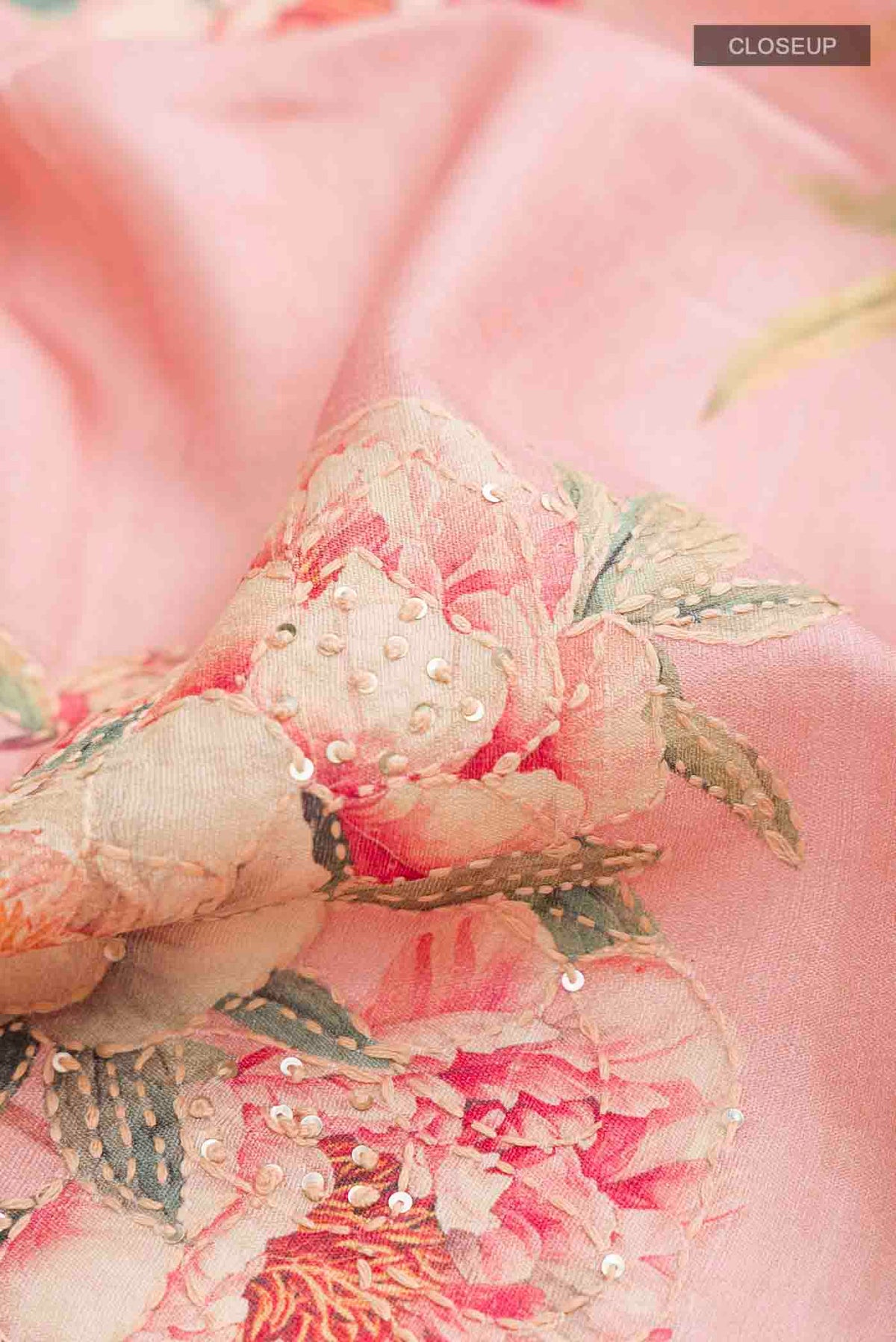 Close up of Rose pink Bhagalpuri Tussar Silk Saree with Embroidery on the body and Zari Border displaying folds
