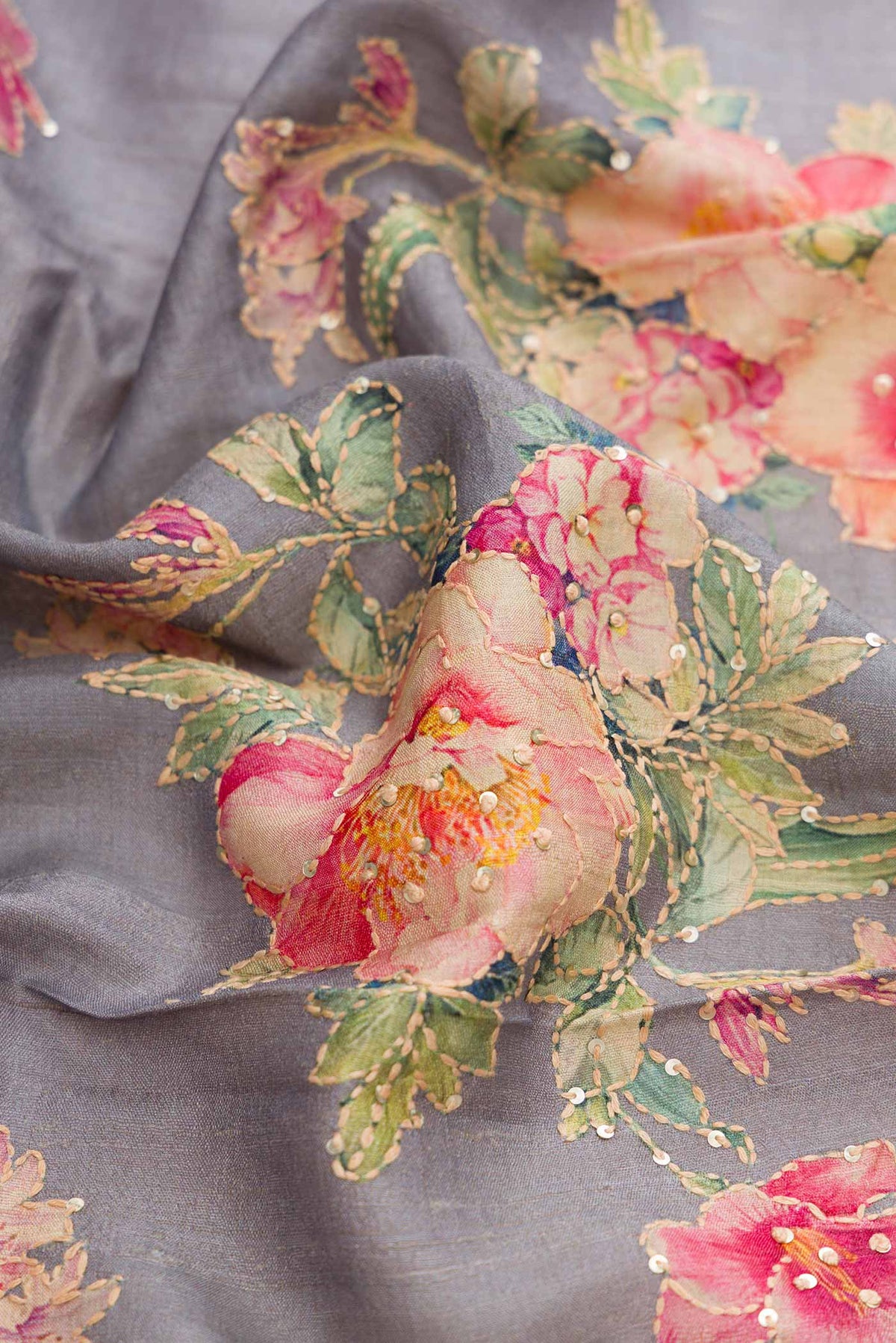 Close up of Grey Dual Tone Tussar Silk Saree with Embroidery on the body and Zari Border displaying folds