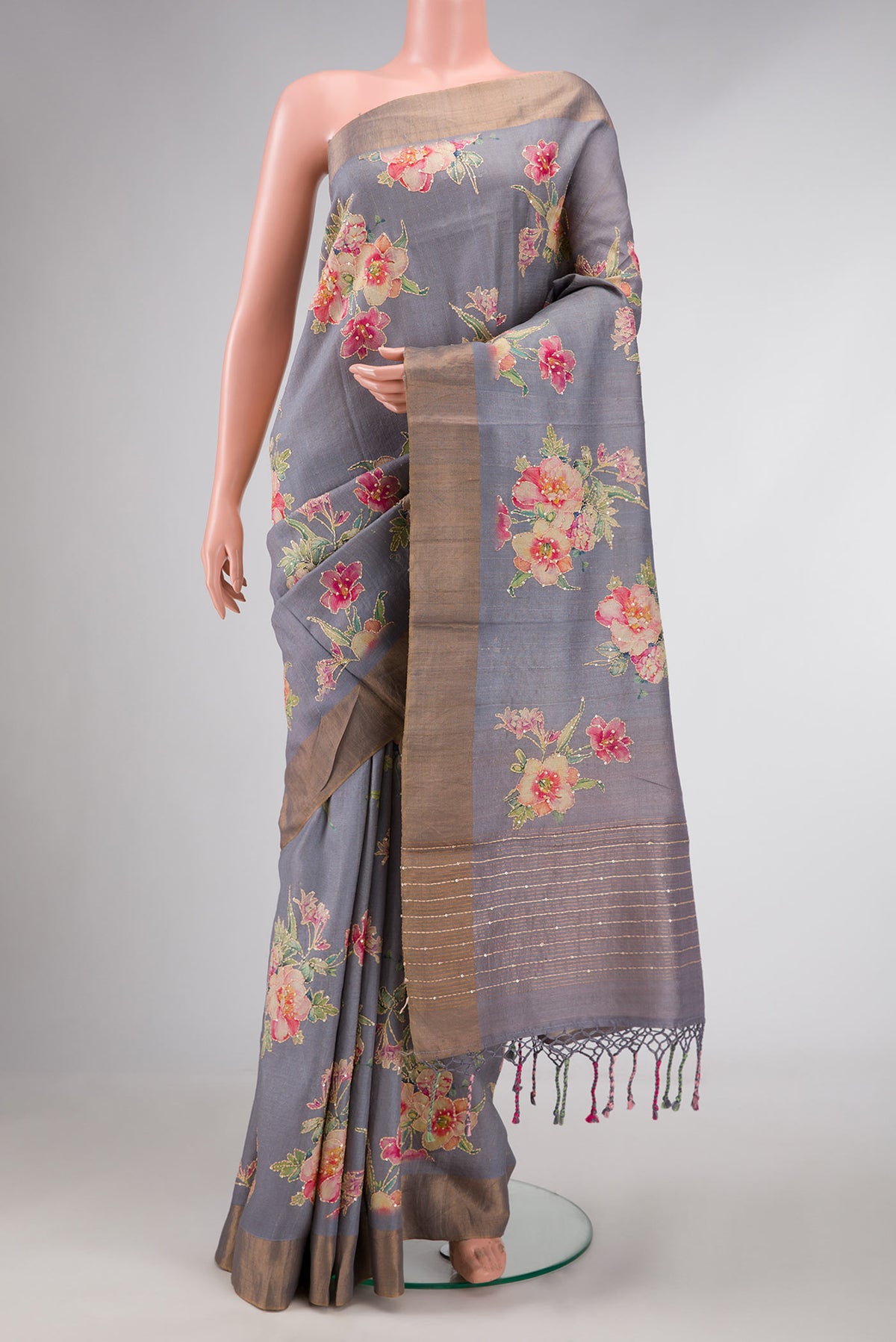 Grey Dual Tone Tussar Silk Saree with Embroidery on the body and Zari Border displayed on a mannequin