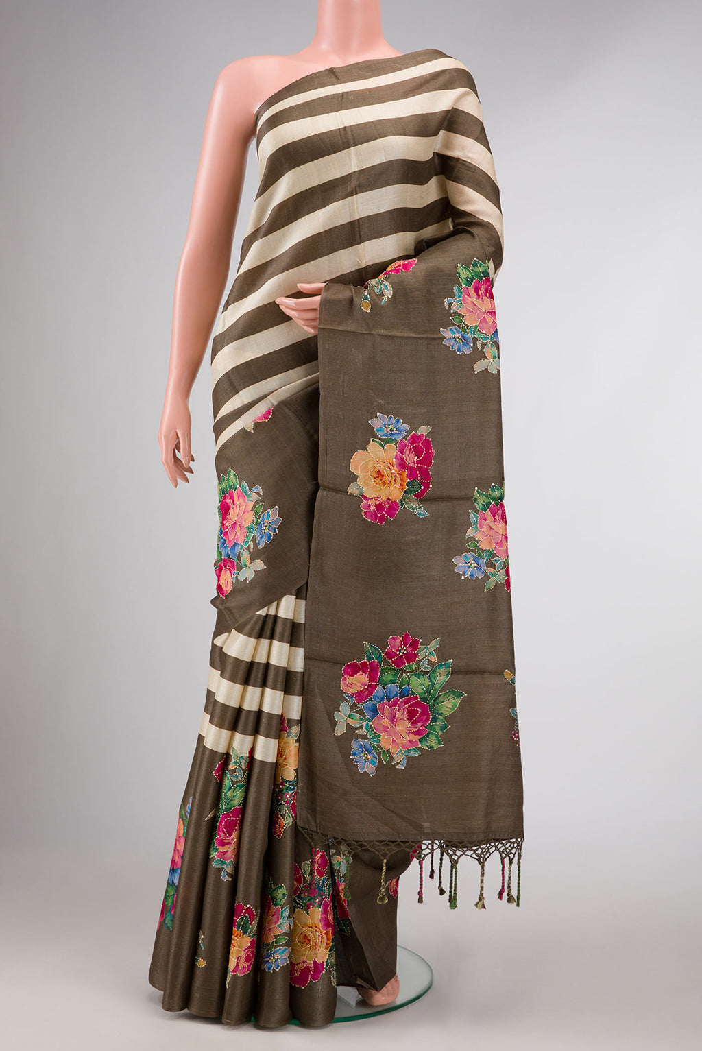 Dark Beige and Sandal Color Tussar Silk Saree with Printed design on the body and Fancy Border displayed on a mannequin