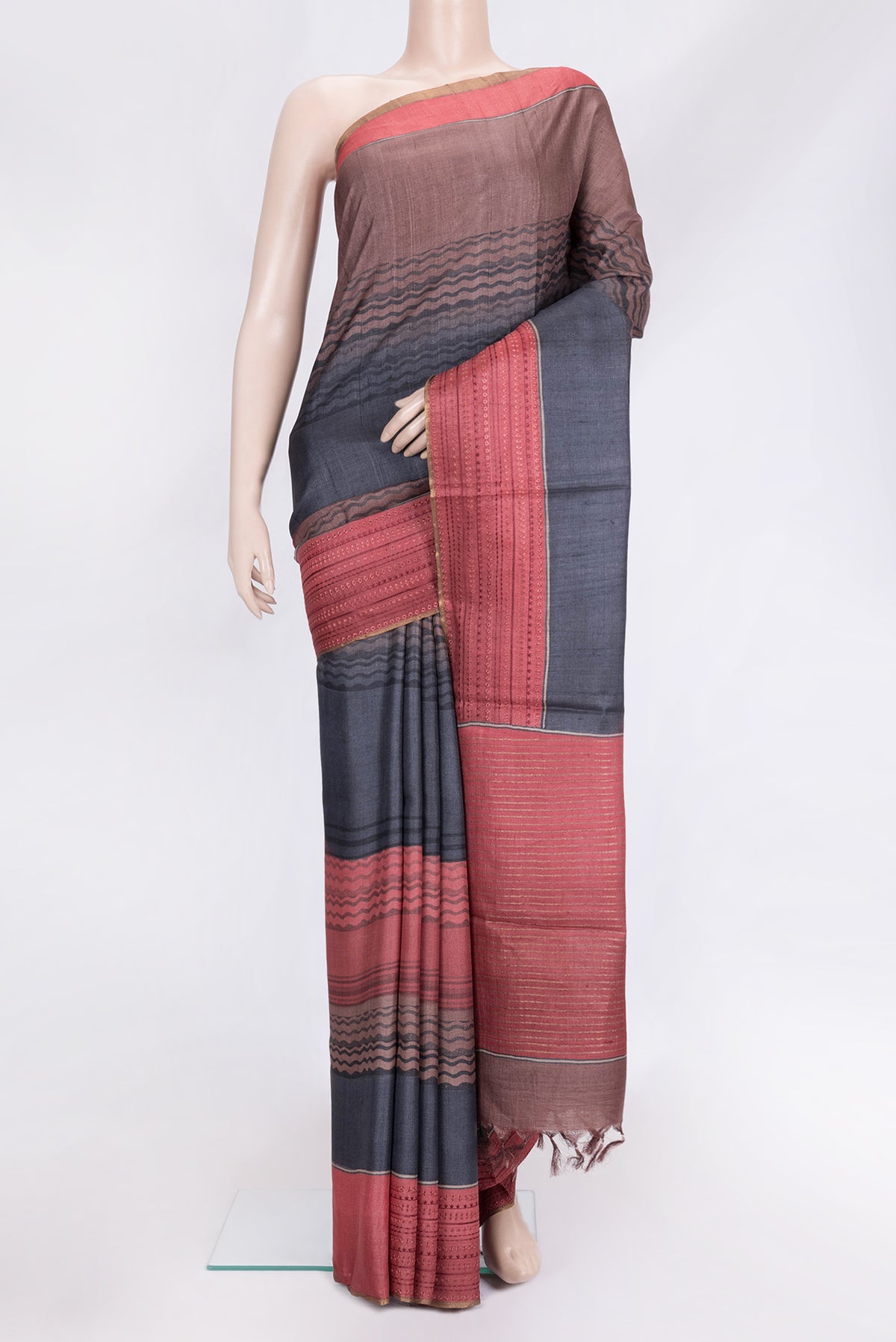 Navy Blue Dual Tone Tussar Silk Saree with Printed design on the body and Embroidery Border.  displayed on a mannequin