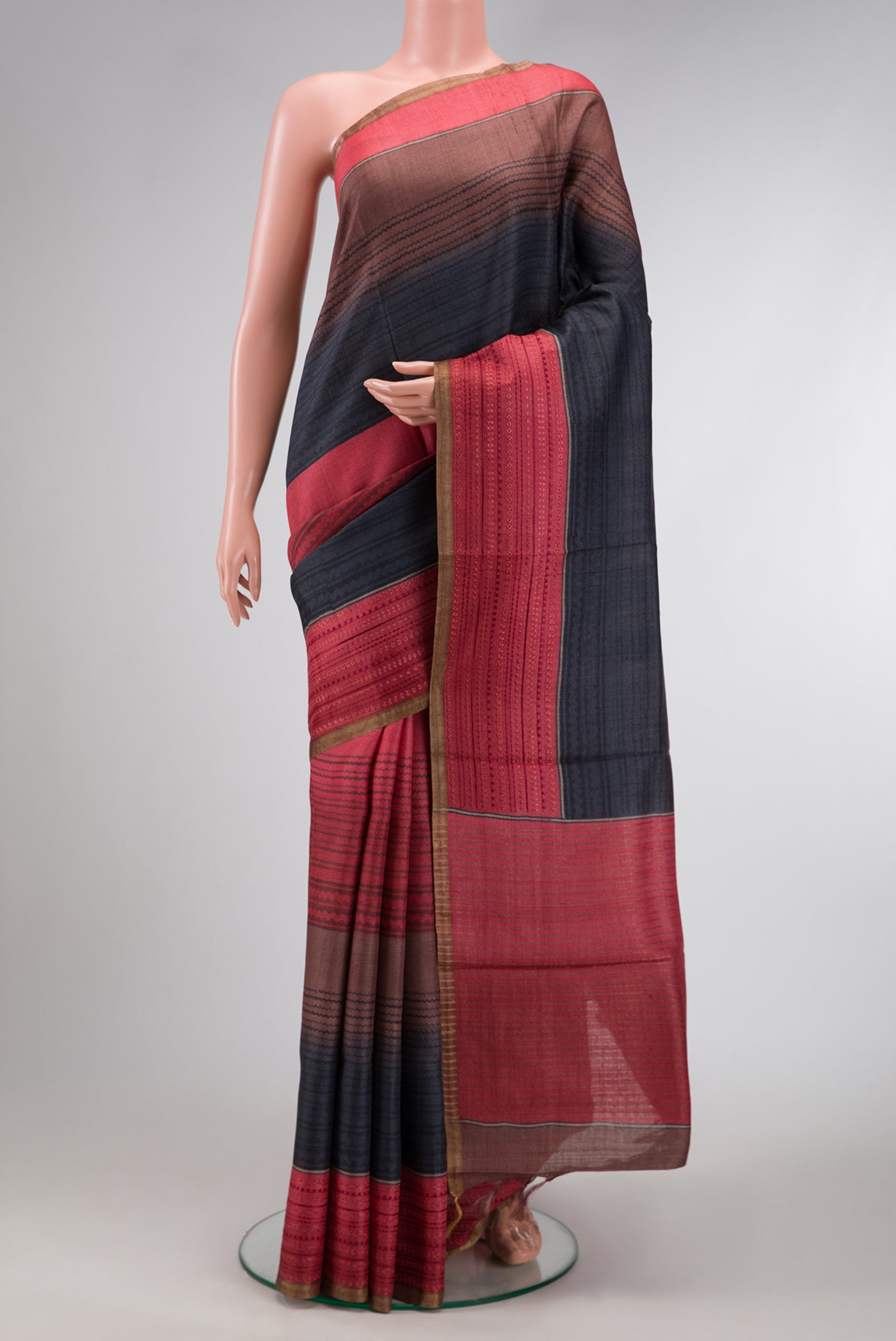 Maroon,Brown and Black Color Tussar Silk Saree with Printed design on the body and Embroidery Border.  displayed on a mannequin