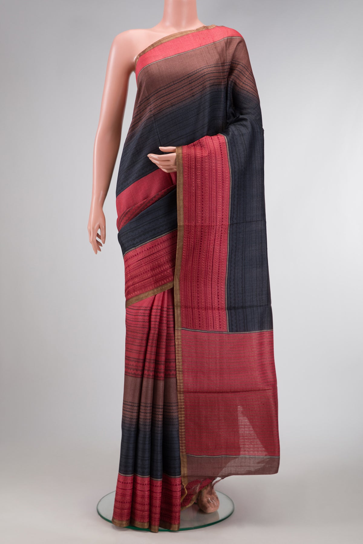 Maroon,Brown and Black Color Tussar Silk Saree with Printed design on the body and Embroidery Border.  displayed on a mannequin