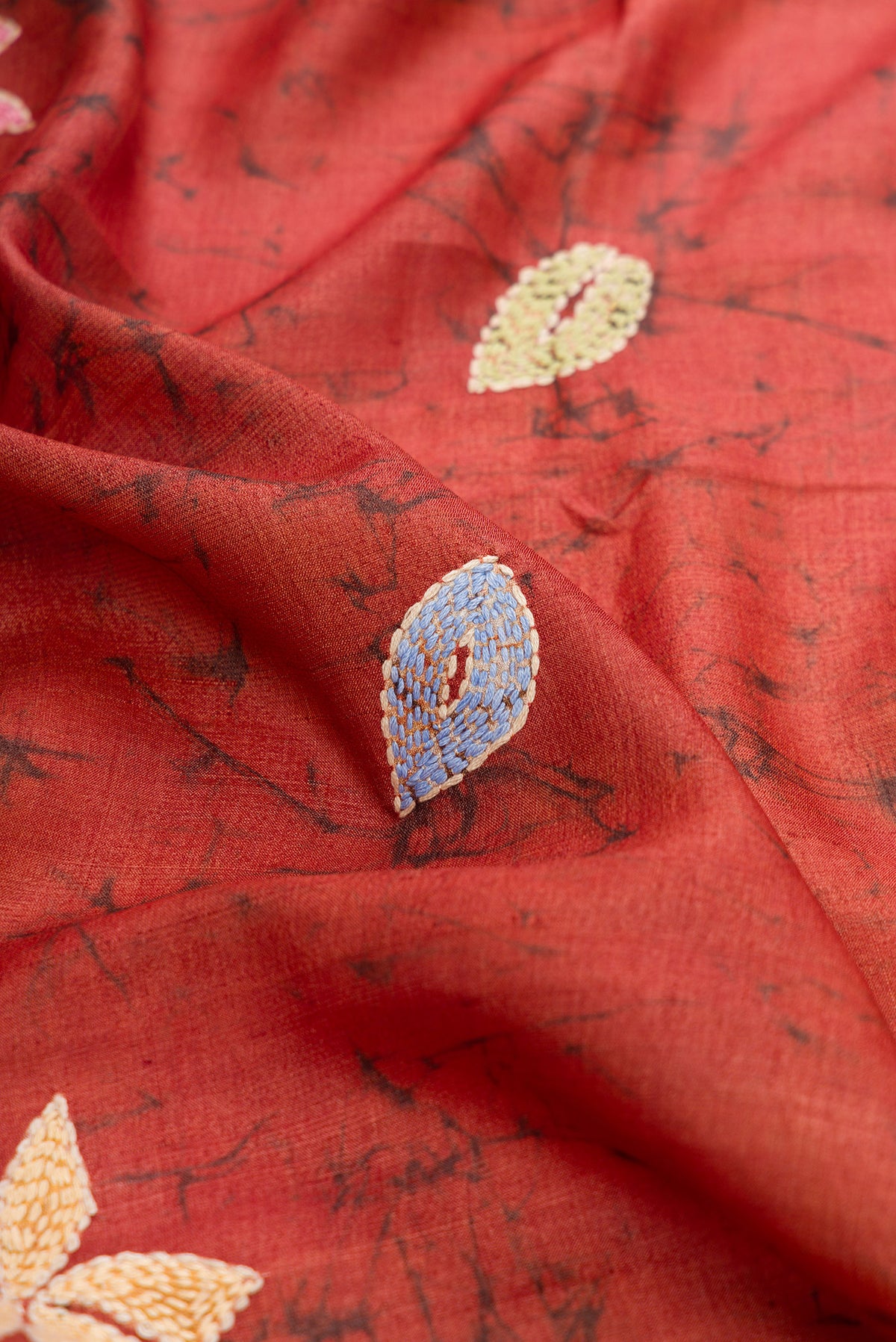 Close up of Brown Dual Tone Tussar Silk Saree with Embroidery on the body and Embroidery Border.  displaying folds