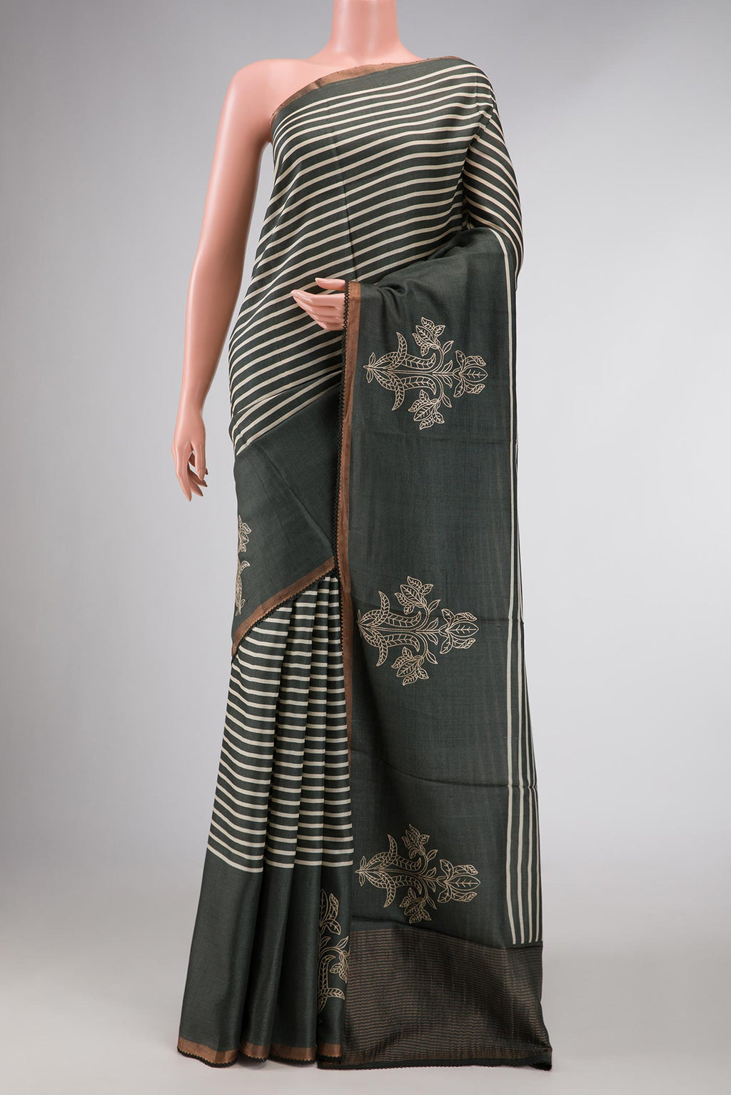 Green Dual Tone Tussar Silk Saree with Stripes on the body and Fancy Border displayed on a mannequin