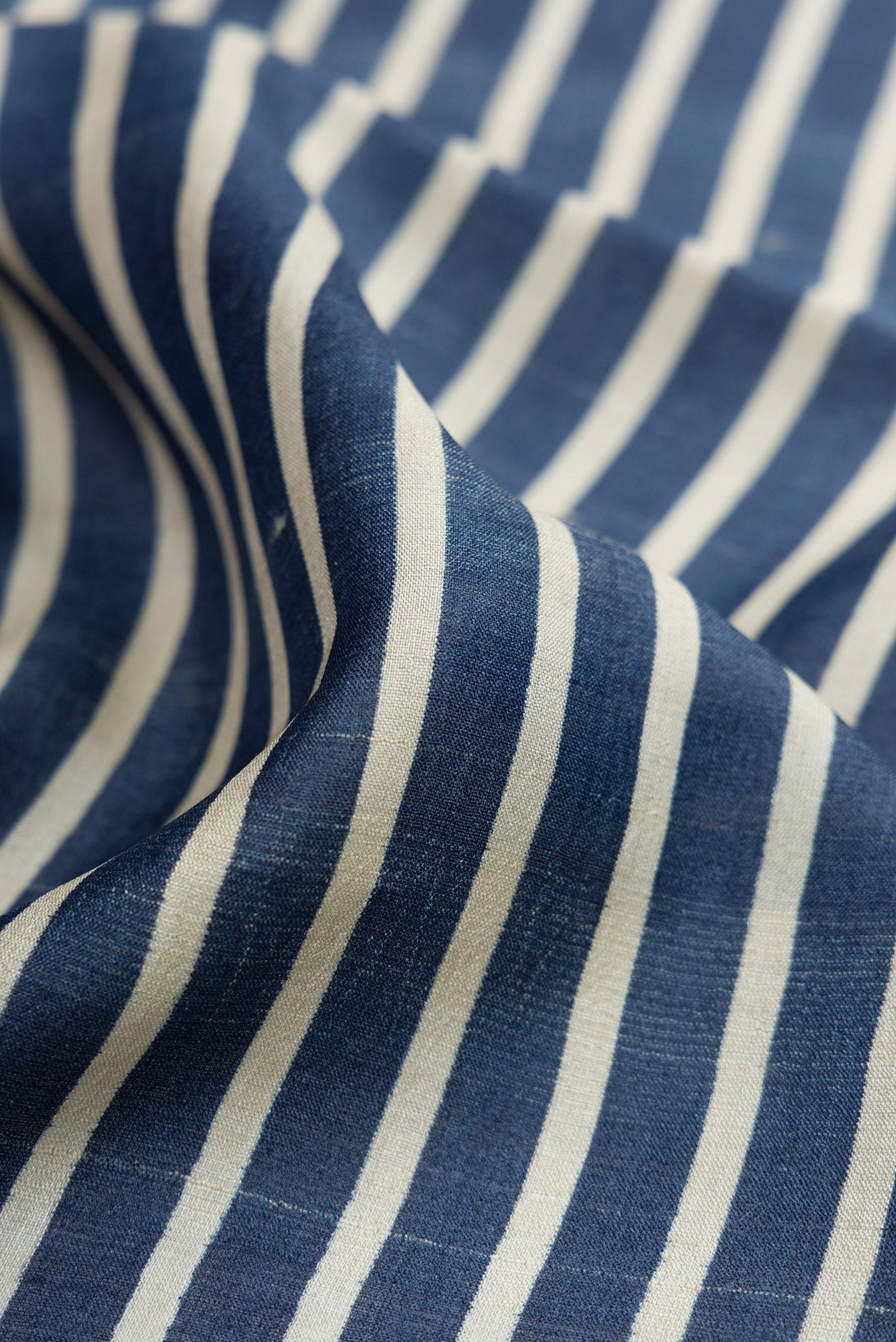 Close up of Navy Blue Dual Tone Tussar Silk Saree with Stripes on the body and Fancy Border.  displaying folds