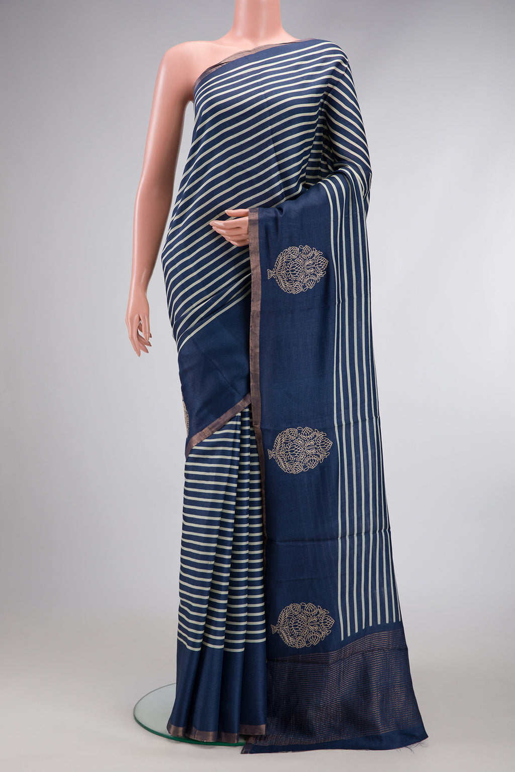 Navy Blue Dual Tone Tussar Silk Saree with Stripes on the body and Fancy Border.  displayed on a mannequin