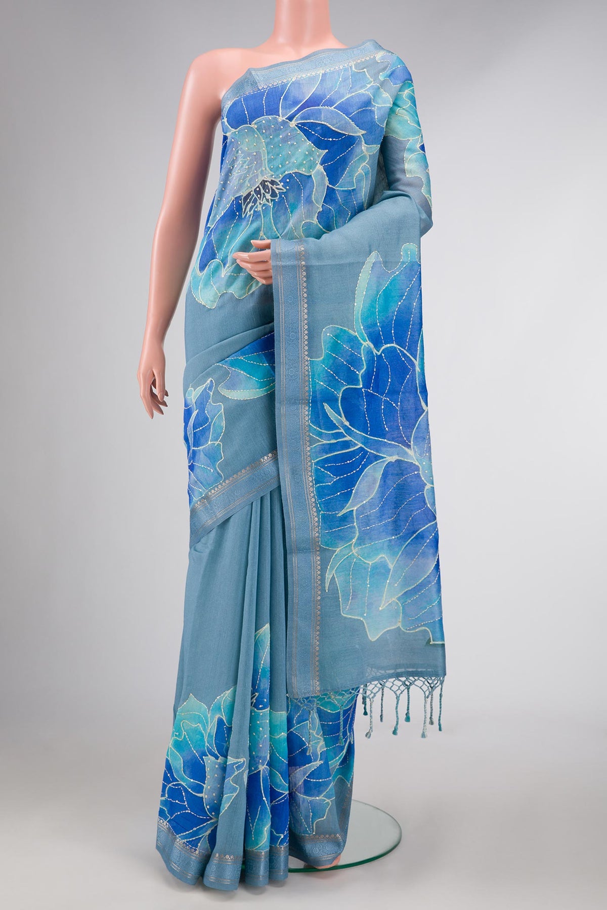 Blue Dual Tone Tussar Silk Saree with Printed design on the body and Zari Border displayed on a mannequin