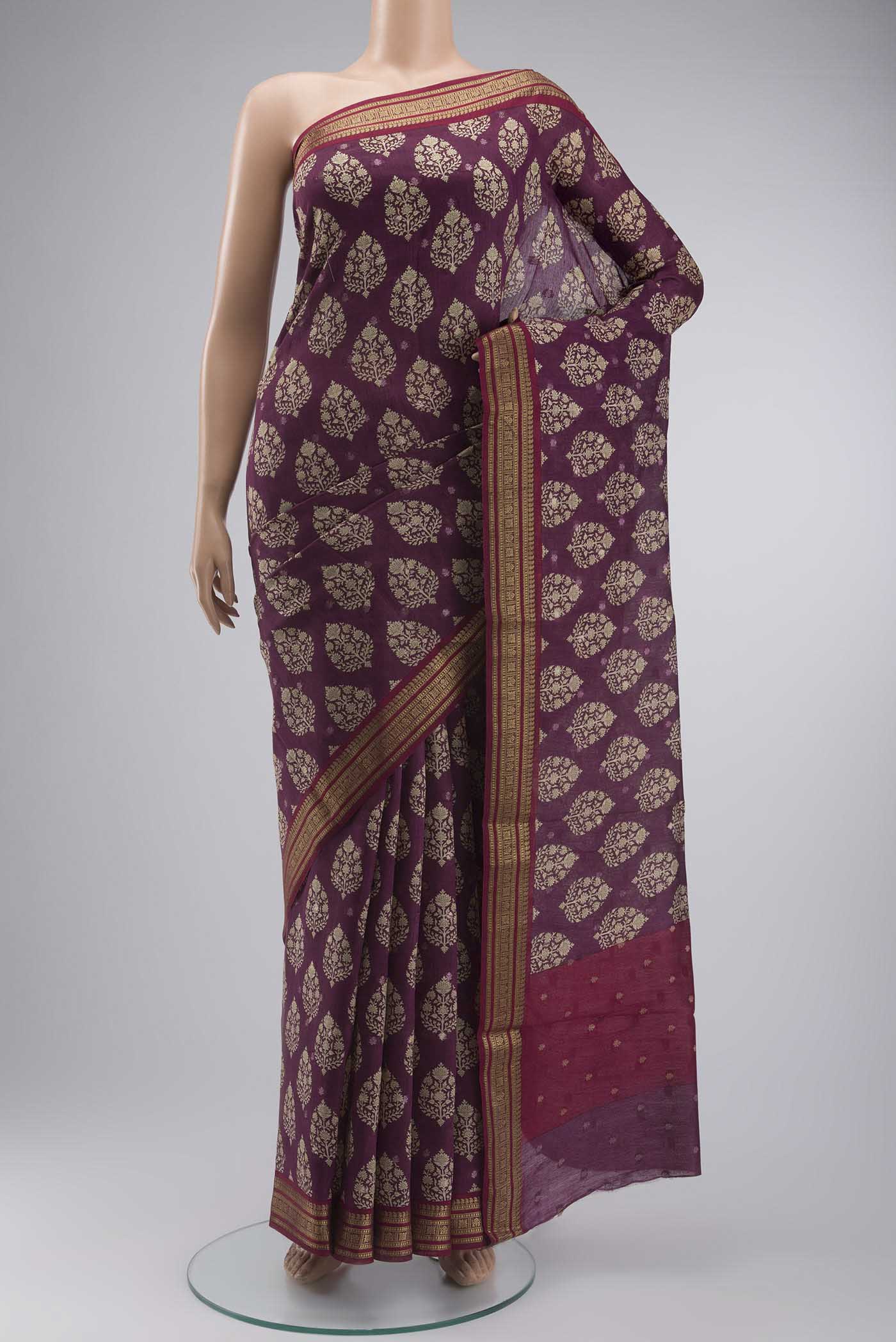 Mauve Tussar Silk Saree with Printed design on the body and Zari Border displayed on a mannequin