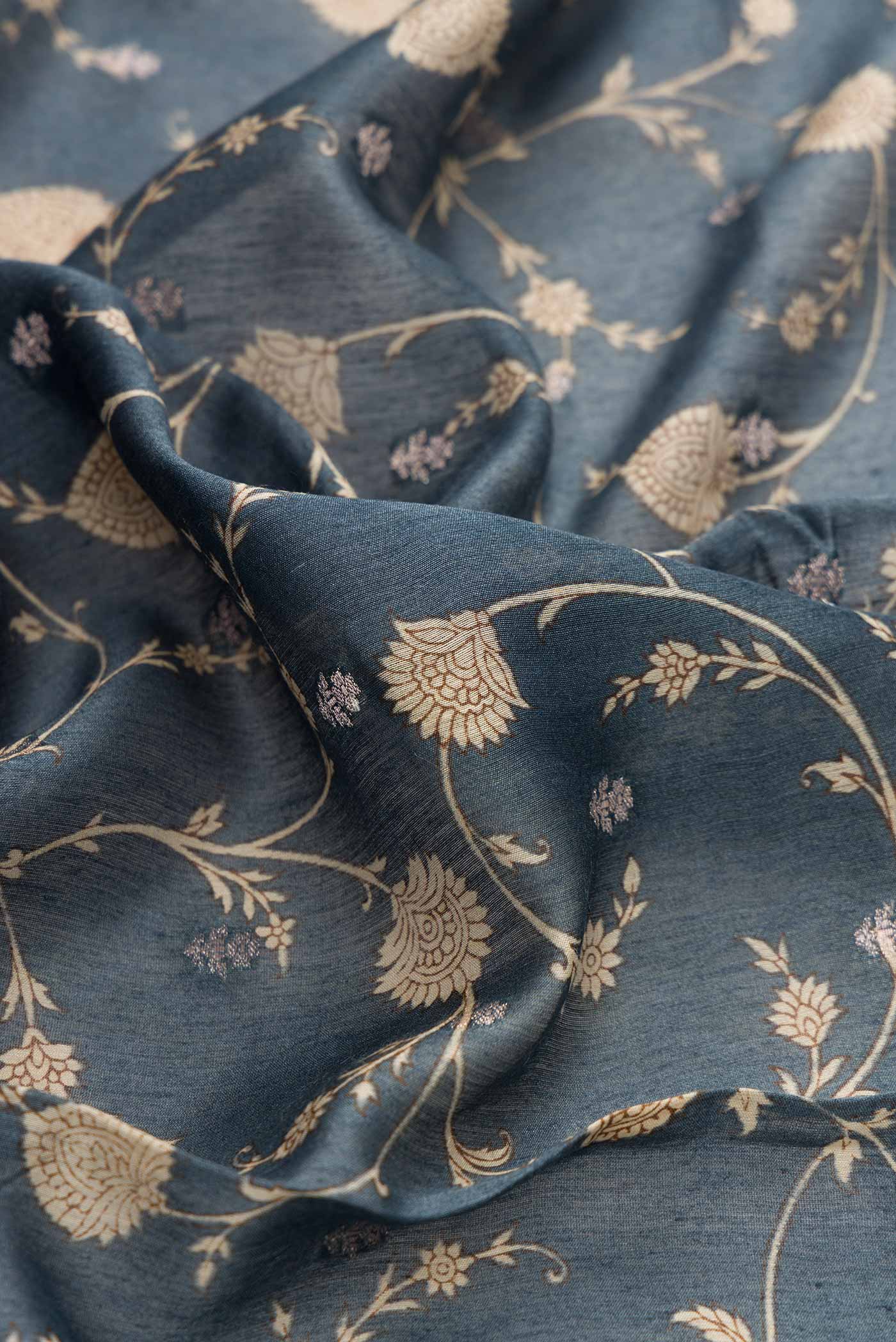 Close up of Davys Grey Dual Tone Tussar Silk Saree with Printed design on the body and Zari Border displaying folds