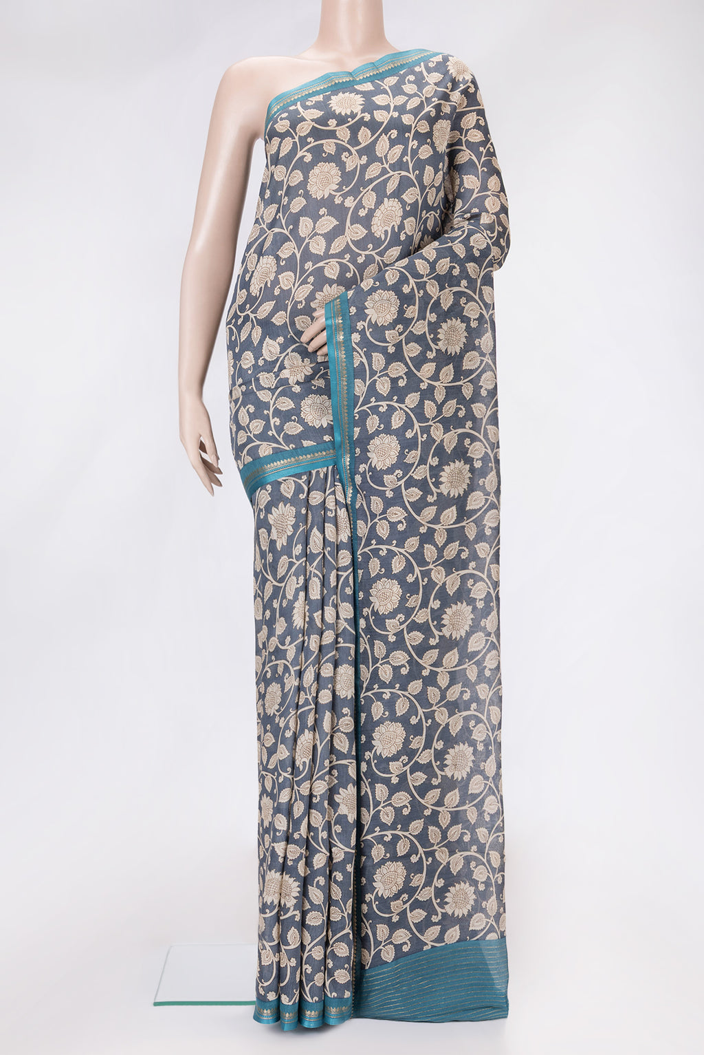Grey Dual Tone Tussar Silk Saree with Printed design on the body and Zari And Thread Border.  displayed on a mannequin